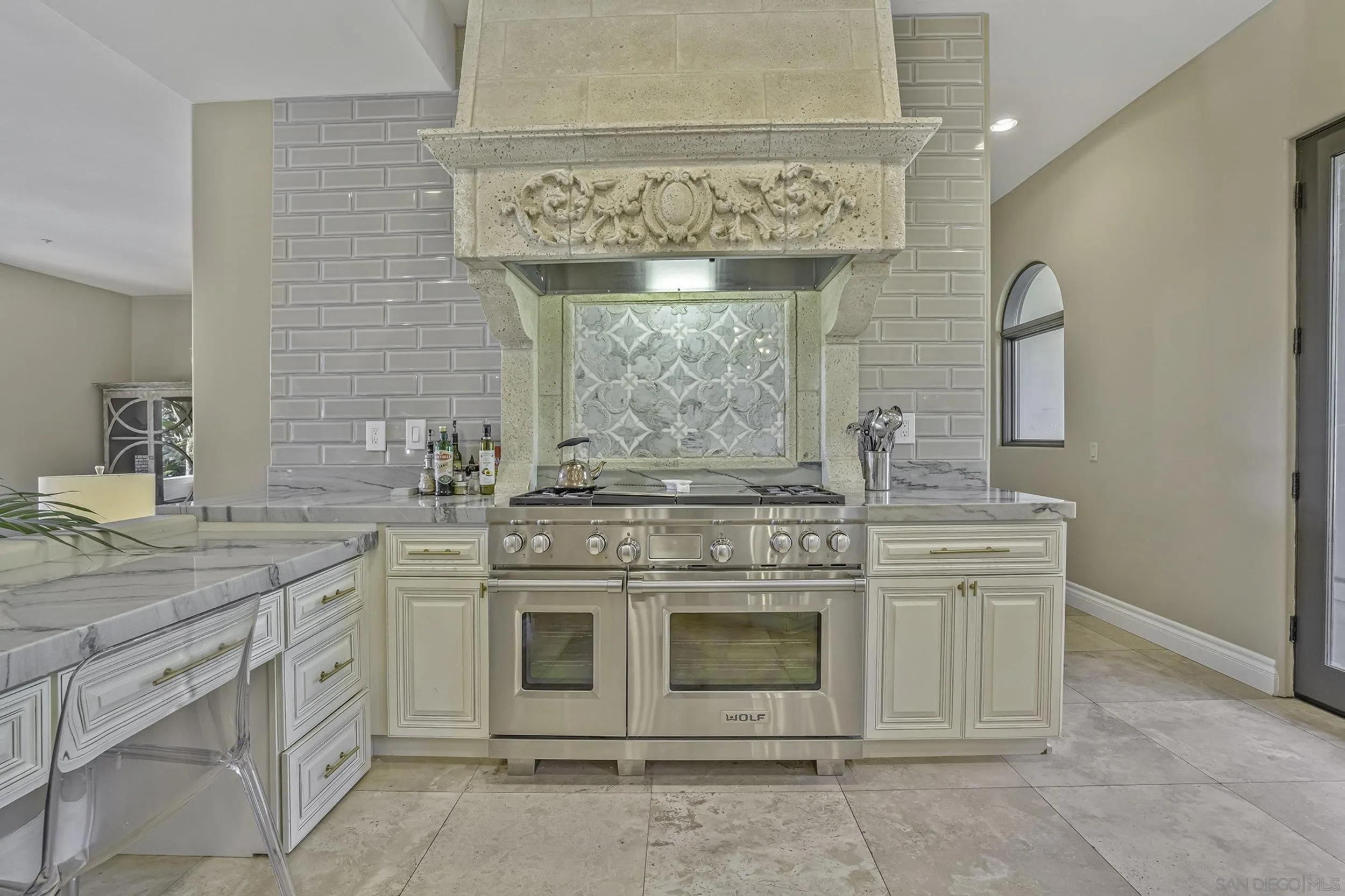 5305 La Crescenta Road Rancho Santa Fe, CA 92067 - Photo 9 of 63 Gorgeous Wolf gas range with griddle and grill and designer precast stone hood , as well as a nice domestic office workspace