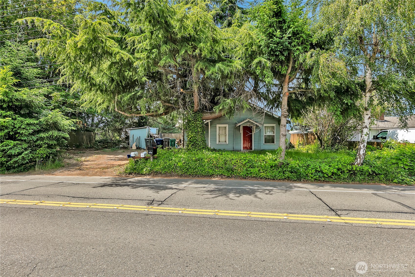 2209 Talbot Road South Renton, WA 98055 - Photo 1 of 8 a house that has a tree in front of it