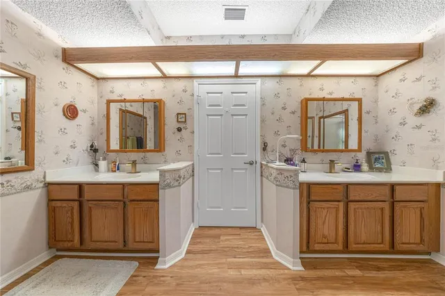 a spacious bathroom with a shower a sink and a mirror
