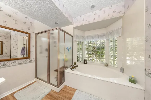 a spacious bathroom with a large tub shower and sink