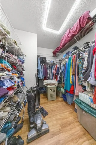 a view of walk in closet with clothes