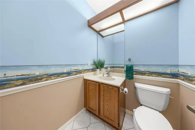 a bathroom with a granite countertop toilet sink and mirror