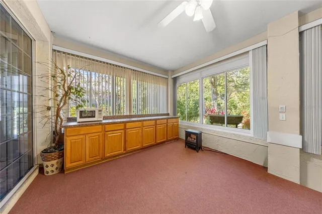 a large white room with a large window and furniture