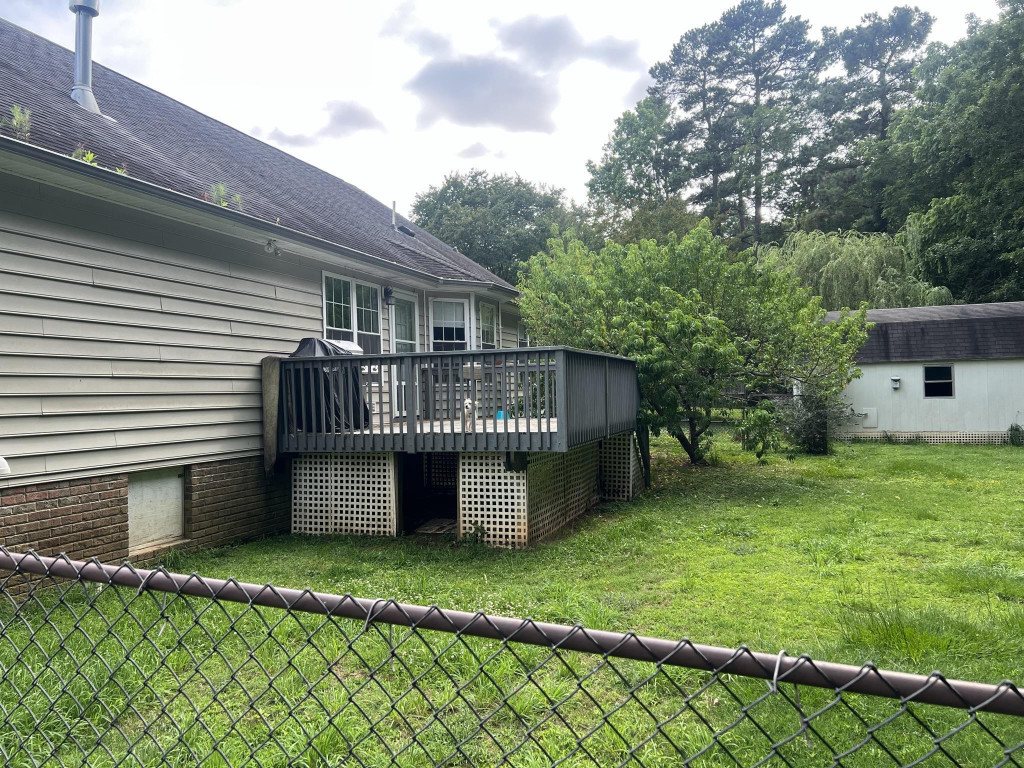 12617 Old Creedmoor Road Raleigh, NC 27613 - Photo 4 of 17 a view of a house with a yard deck and a garden