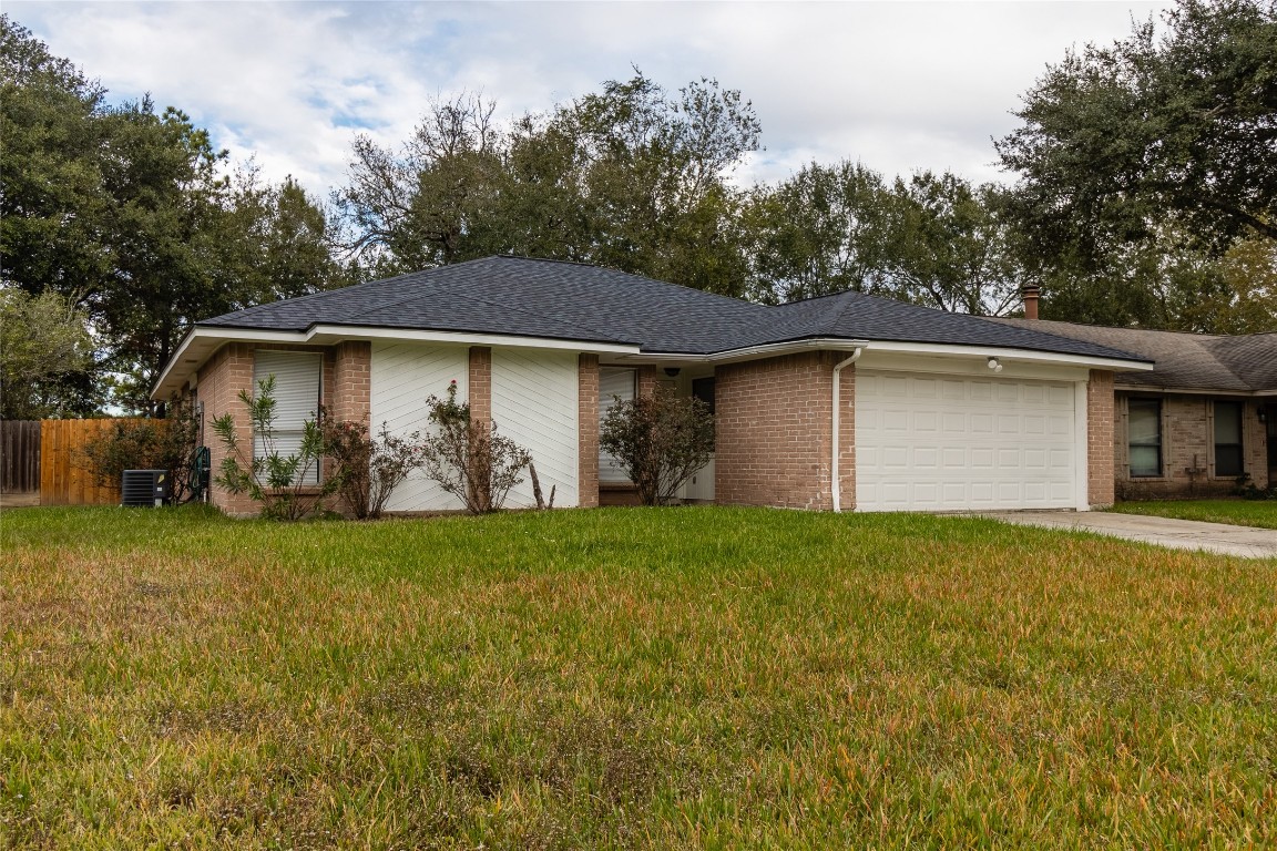 23430 Wintergate Drive Spring, TX 77373 - Photo 1 of 33 a house with green field in front of it