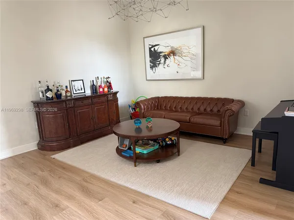 a living room with furniture and wooden floor