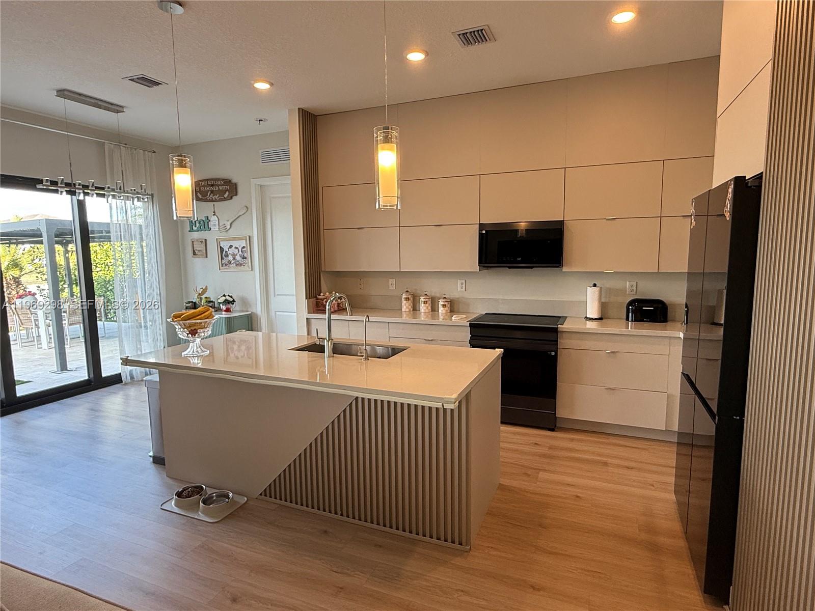 17507 Southwest 43rd Street Miramar, FL 33029 - Photo 19 of 25 a large white kitchen with a large window a sink and stainless steel appliances