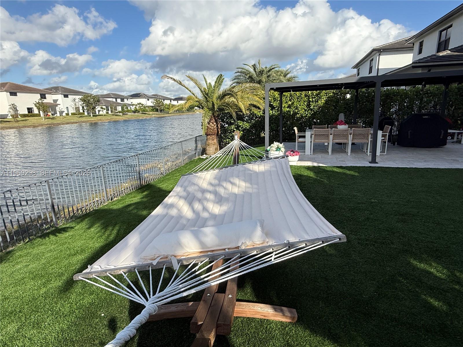 17507 Southwest 43rd Street Miramar, FL 33029 - Photo 23 of 25 a view of a swimming pool with lawn chairs and a yard