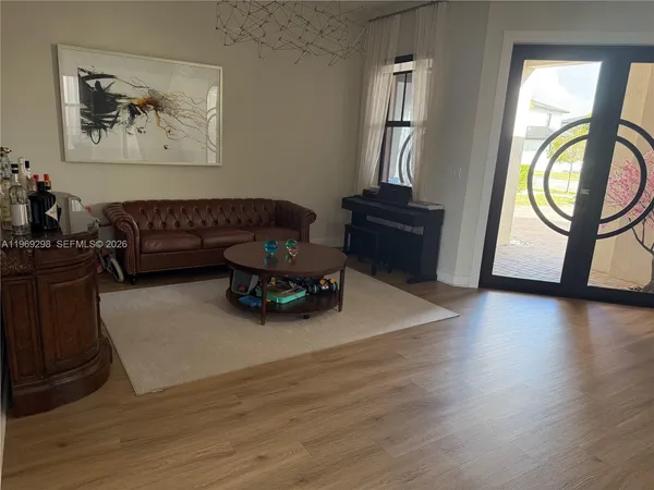 a living room with furniture and a dining table