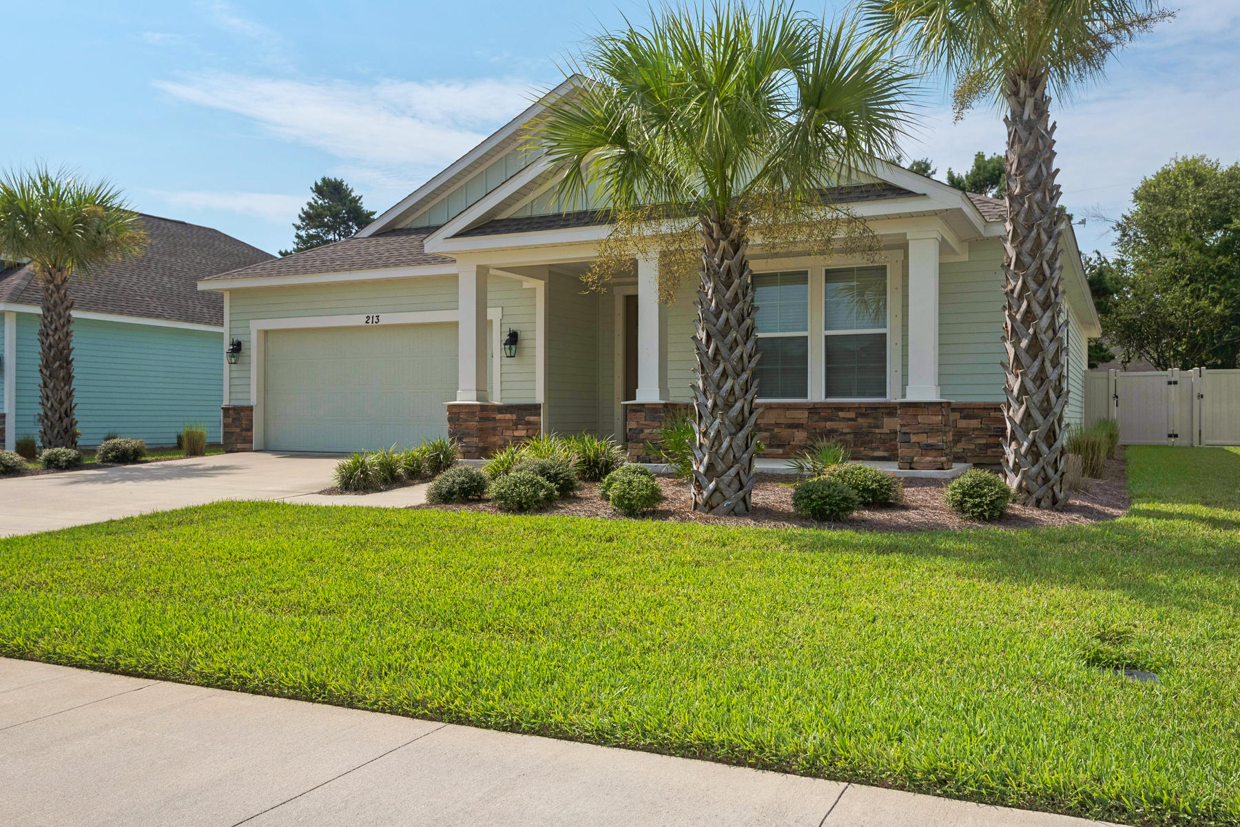213 Blue Sage Road Panama City Beach, FL 32413 - Photo 1 of 24 a front view of house with yard and green space