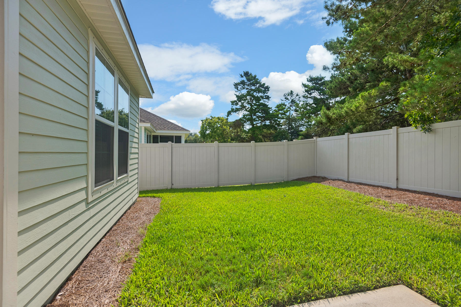 213 Blue Sage Road Panama City Beach, FL 32413 - Photo 17 of 24 a view of a backyard with a garden and stairs