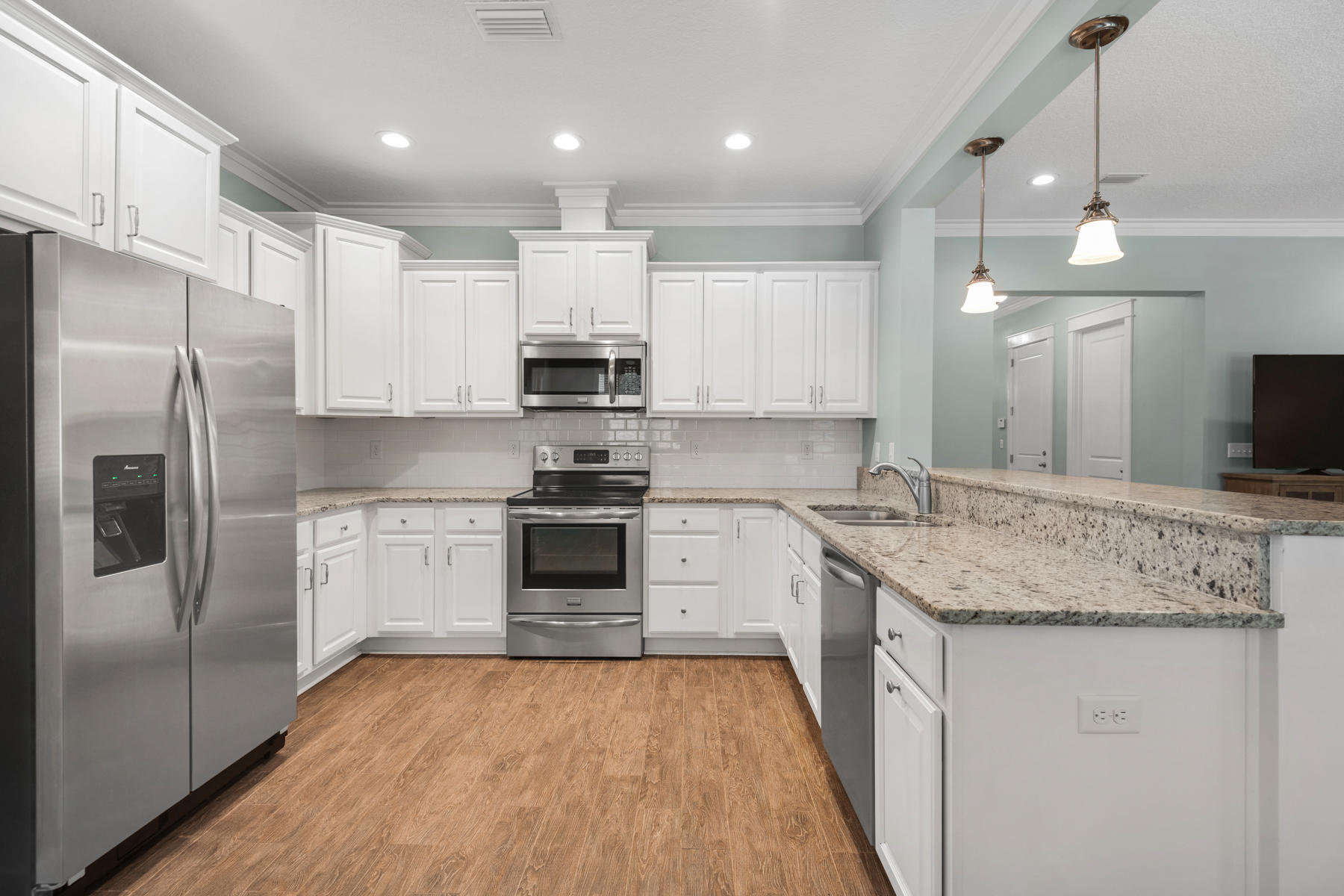 213 Blue Sage Road Panama City Beach, FL 32413 - Photo 3 of 24 a kitchen with stainless steel appliances granite countertop a sink stove and refrigerator