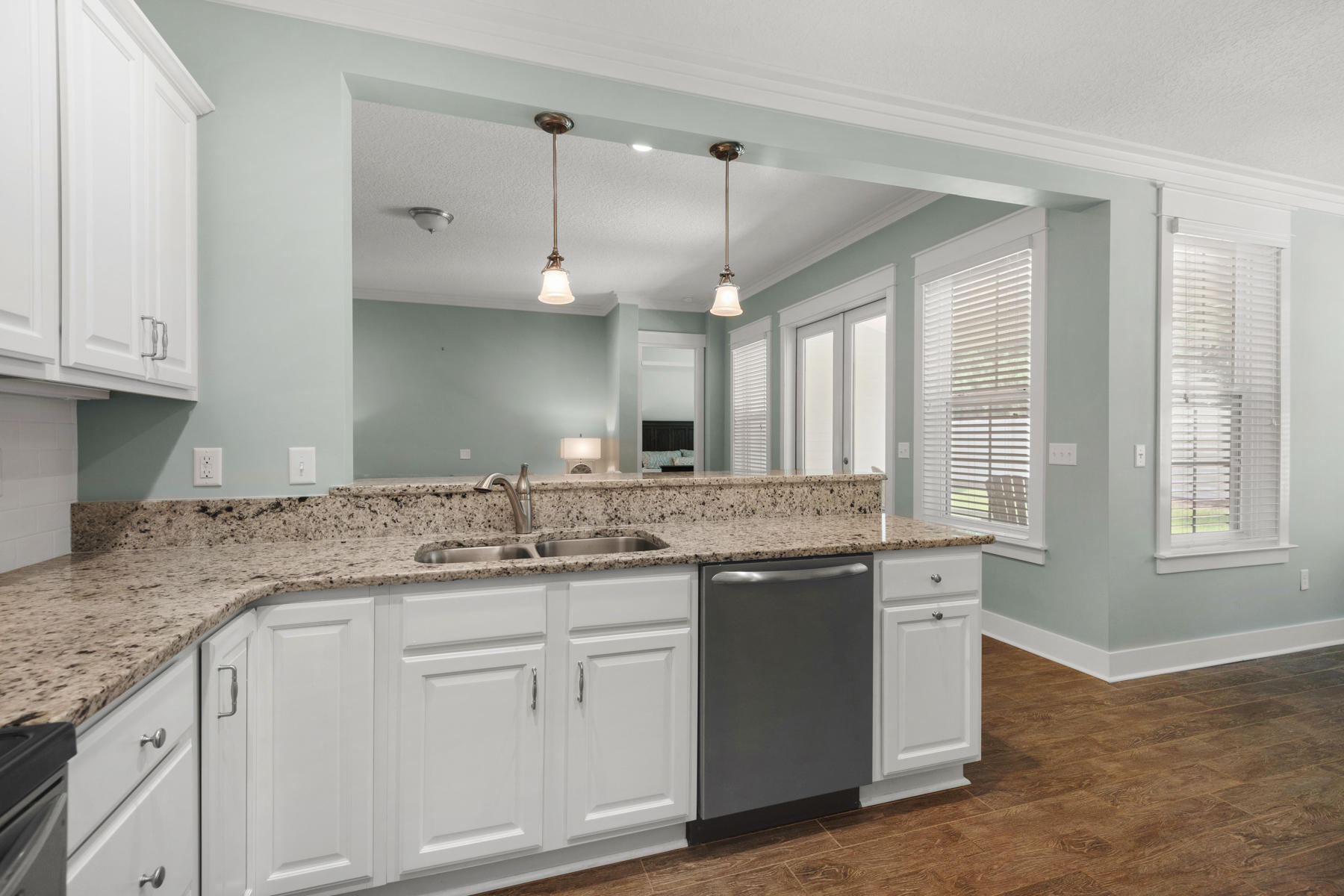 213 Blue Sage Road Panama City Beach, FL 32413 - Photo 4 of 24 a kitchen with granite countertop a sink cabinets and wooden floor