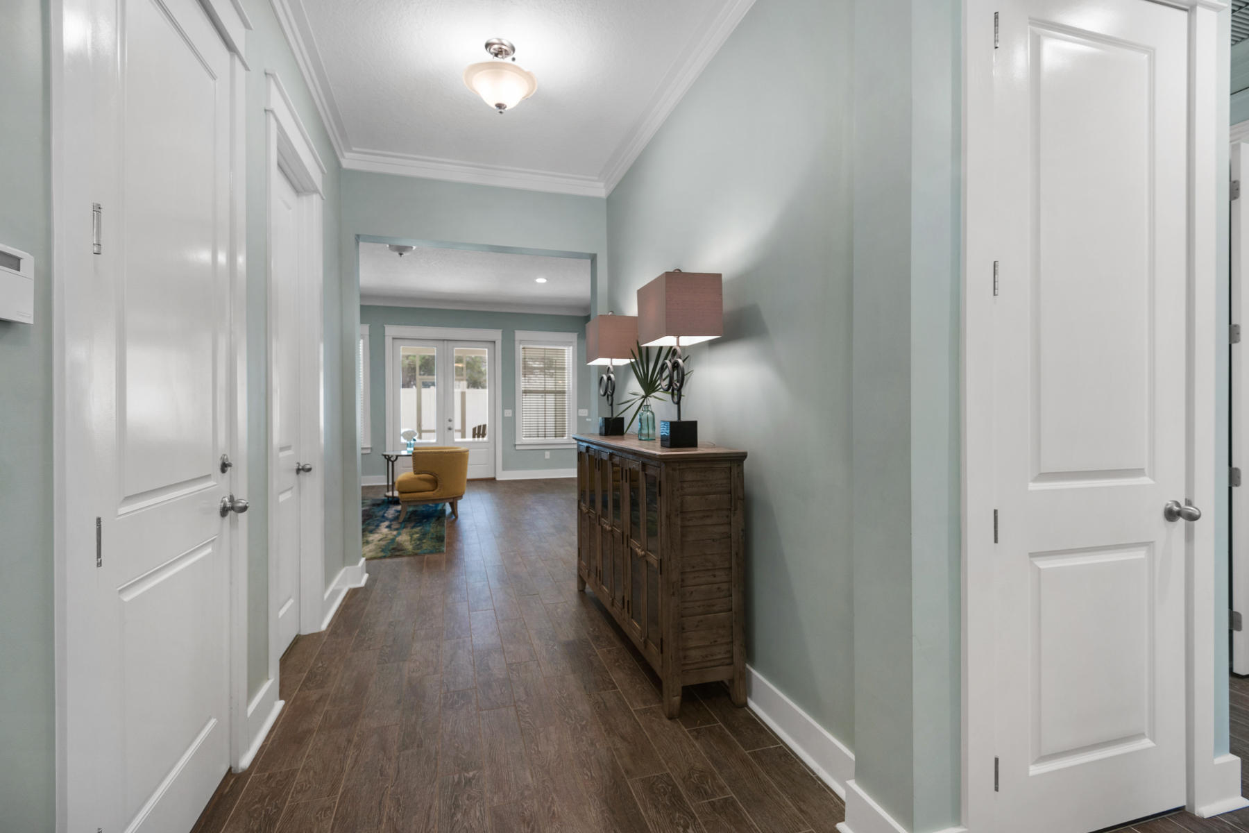 213 Blue Sage Road Panama City Beach, FL 32413 - Photo 5 of 24 a view of a hallway view with wooden floor and furniture