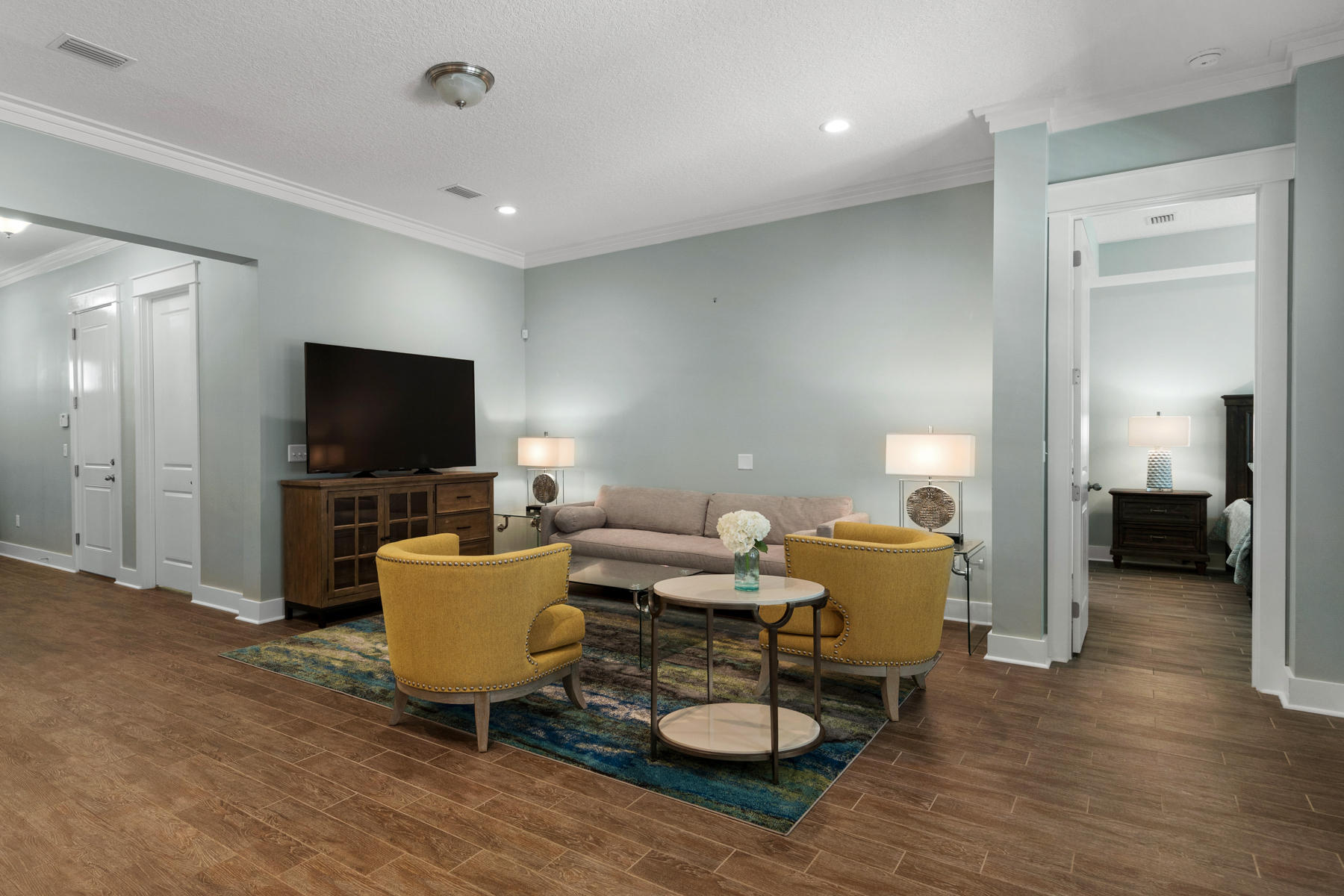 213 Blue Sage Road Panama City Beach, FL 32413 - Photo 8 of 24 a living room with furniture and a flat screen tv