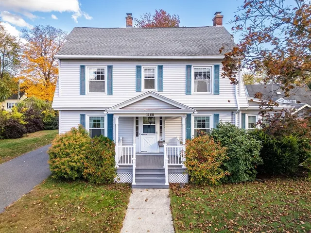 a view of a hallway with wooden floor and entryway