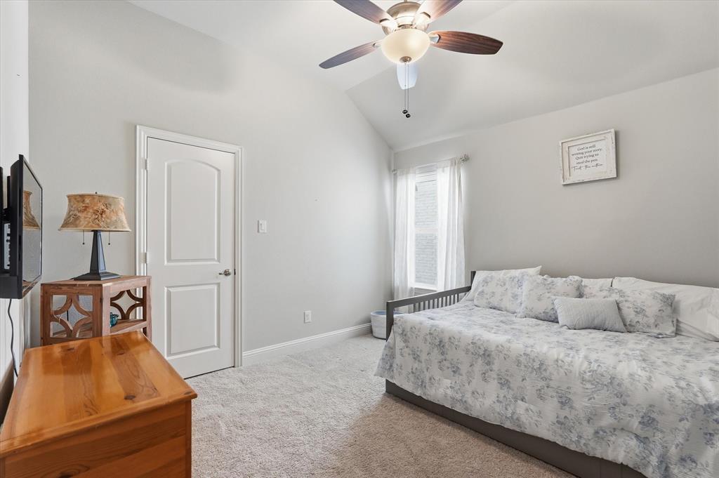 813 Mildren Lane Fate, TX 75087 - Photo 17 of 32 This secondary bedroom is the 2nd of 2 bedrooms in the middle hallway with access to a full bathroom as well as the laundry room. This room also features a vaulted ceiling with ceiling fan as well as a walk-in closet.