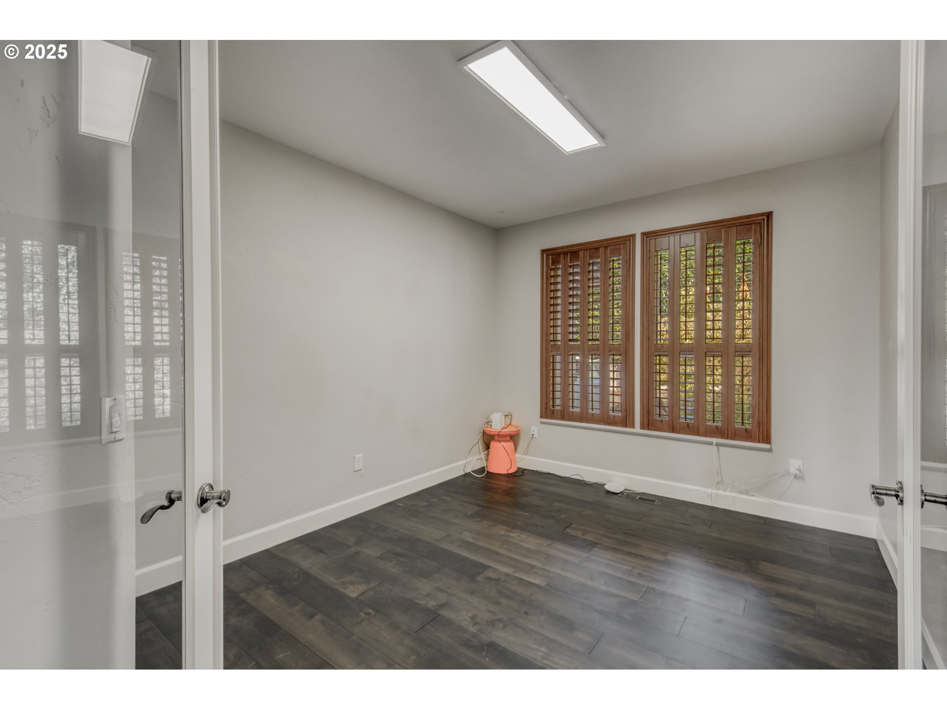 4907 Northwest Highpoint Drive Camas, WA 98607 - Photo 18 of 48 a view of an empty room with wooden floor and a window