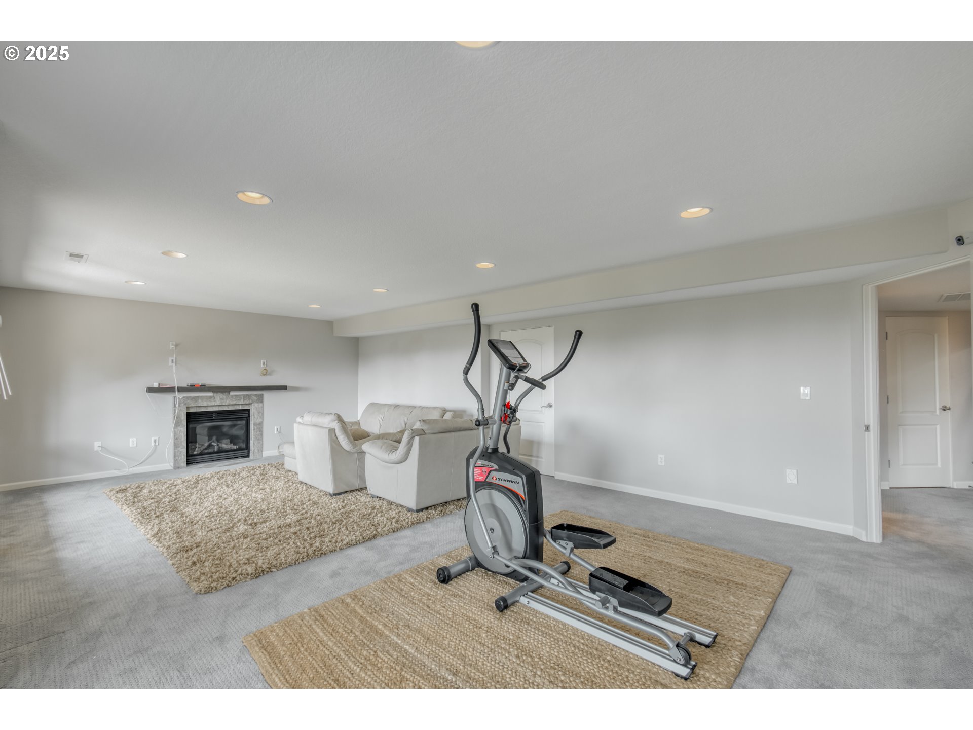 4907 Northwest Highpoint Drive Camas, WA 98607 - Photo 30 of 48 a room with gym equipment and a fireplace