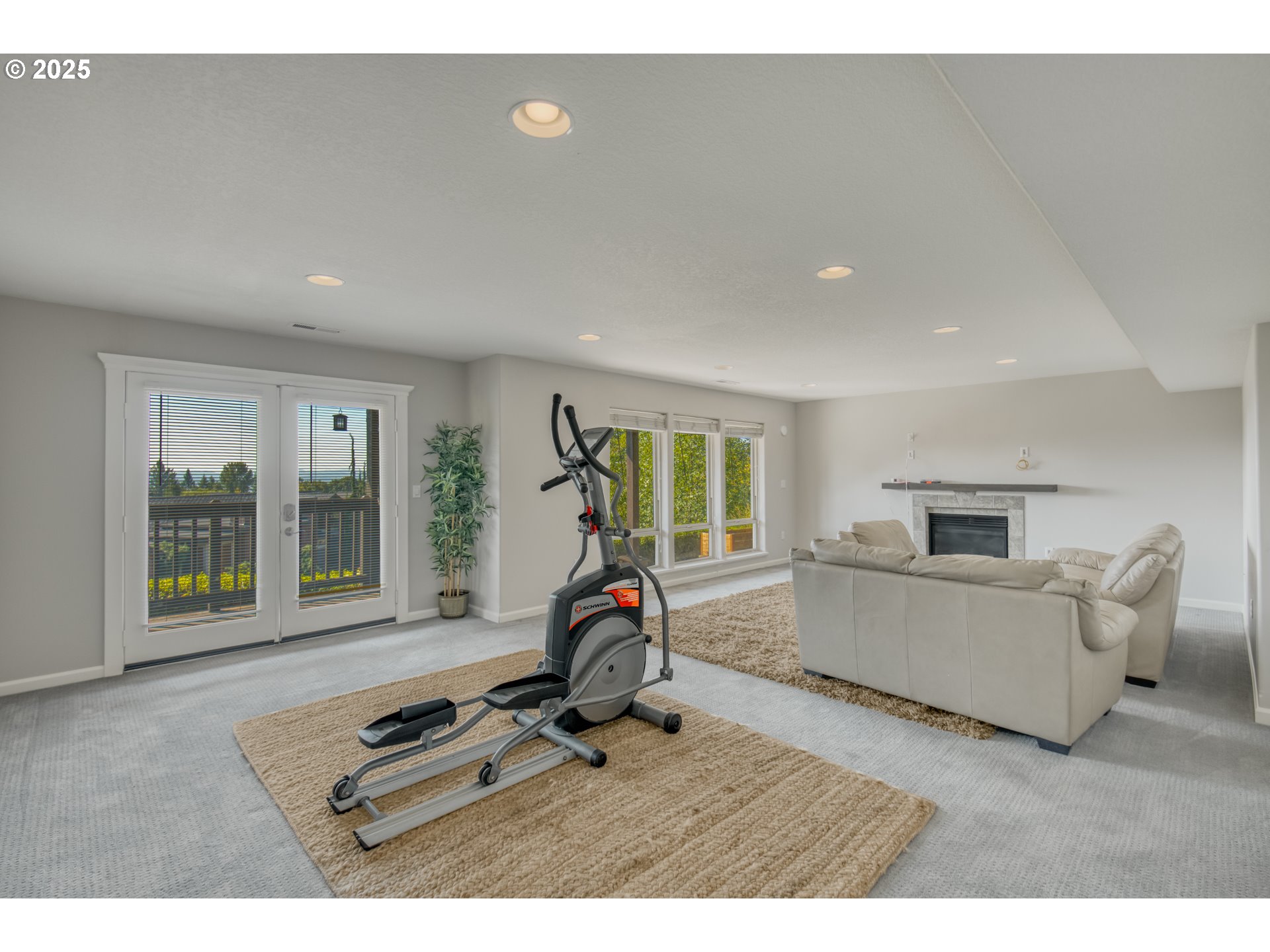 4907 Northwest Highpoint Drive Camas, WA 98607 - Photo 31 of 48 a living room with furniture gym equipment and a large window