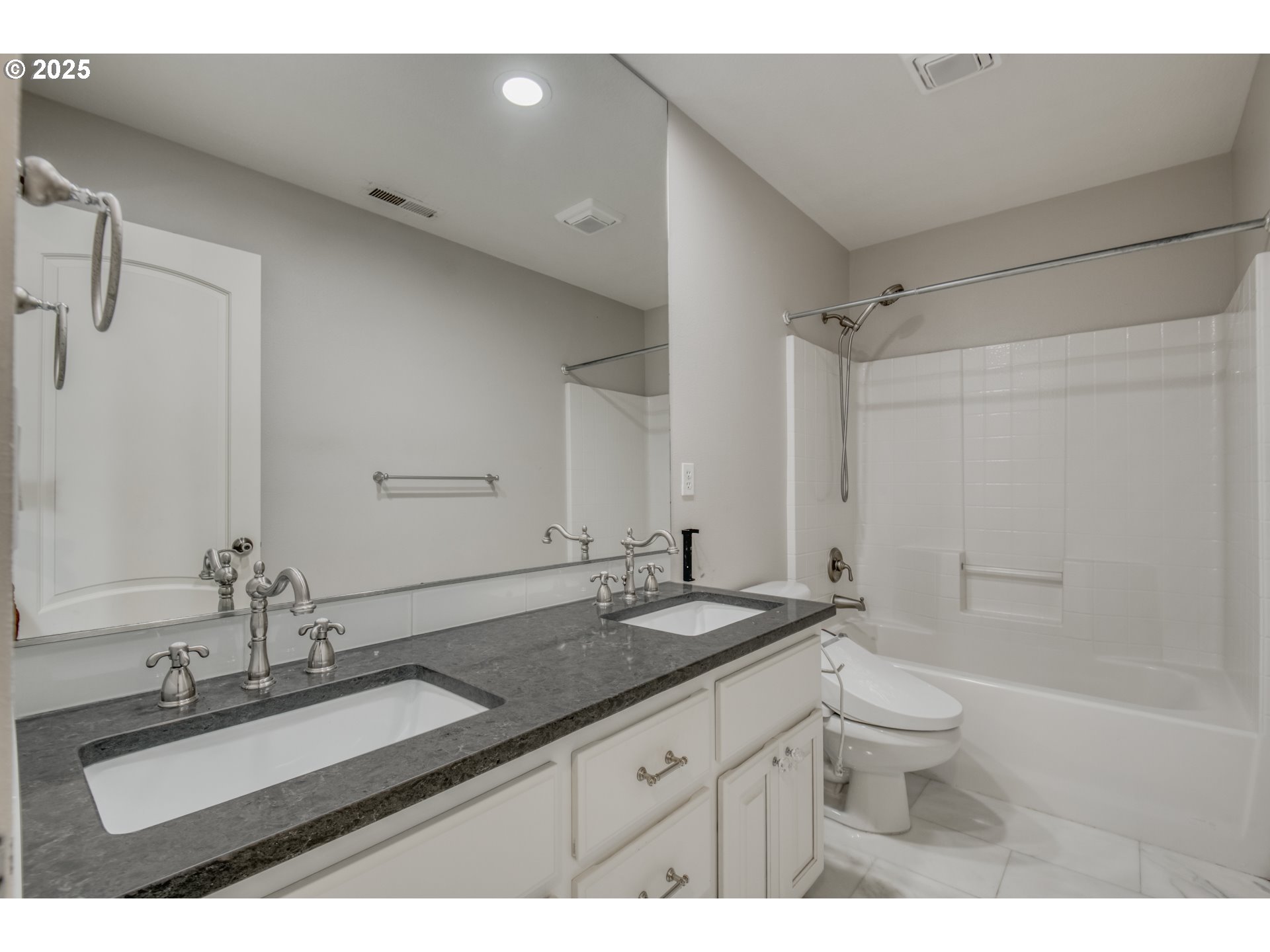 4907 Northwest Highpoint Drive Camas, WA 98607 - Photo 38 of 48 a bathroom with a granite countertop sink a toilet a mirror and shower