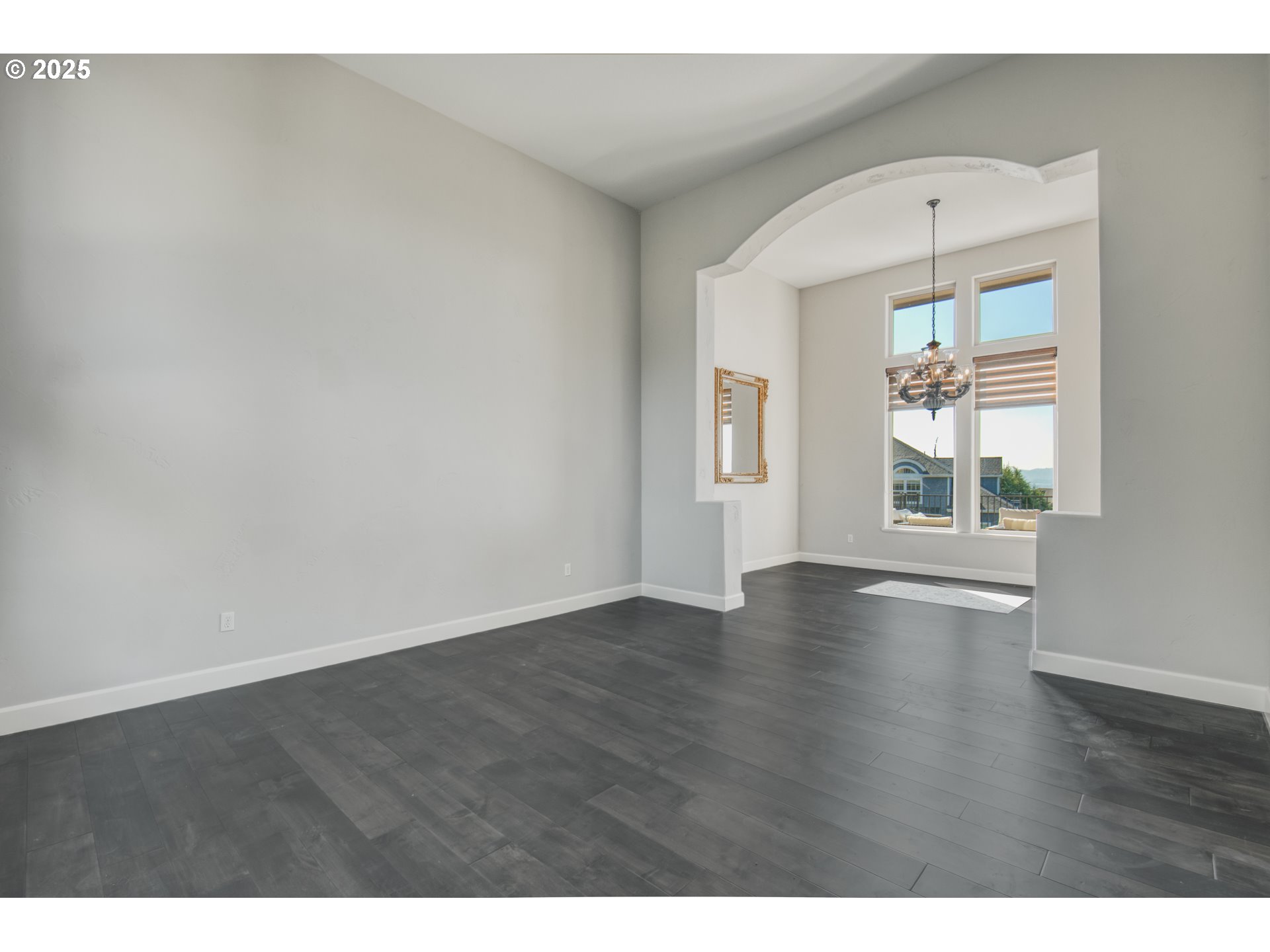 4907 Northwest Highpoint Drive Camas, WA 98607 - Photo 7 of 48 a view of an empty room with wooden floor and a window