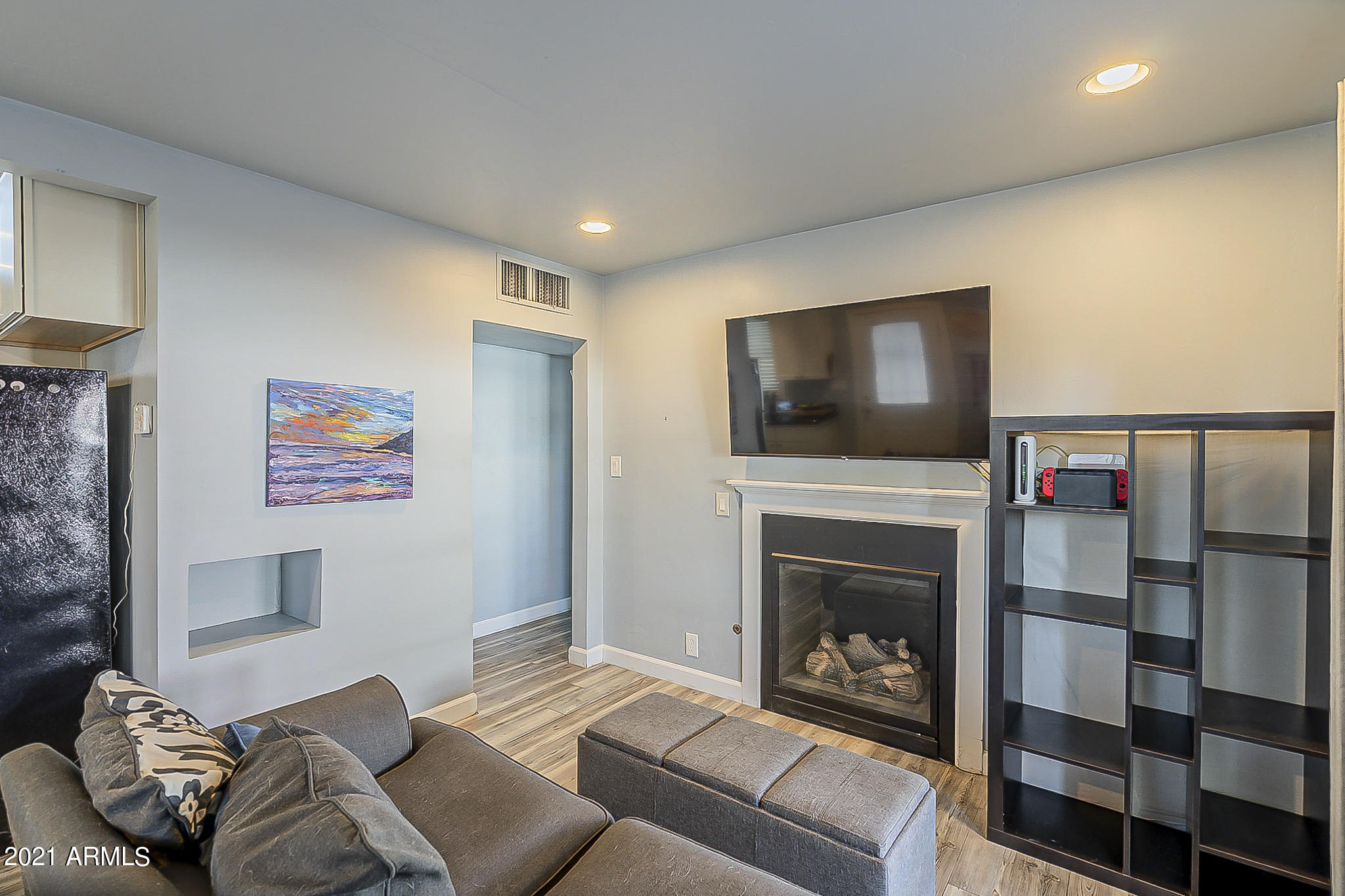 1802 East Cheery Lynn Road Phoenix, AZ 85016 - Photo 5 of 29 a living room with furniture a flat screen tv and a fireplace