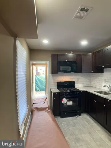 a kitchen with kitchen island granite countertop stainless steel appliances and a counter top space