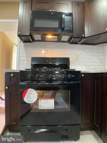 a stove sitting inside of a kitchen