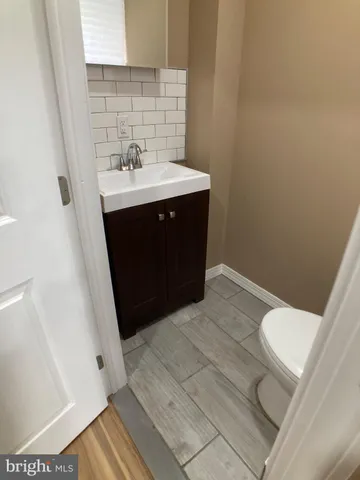 a white toilet sitting next to a white sink