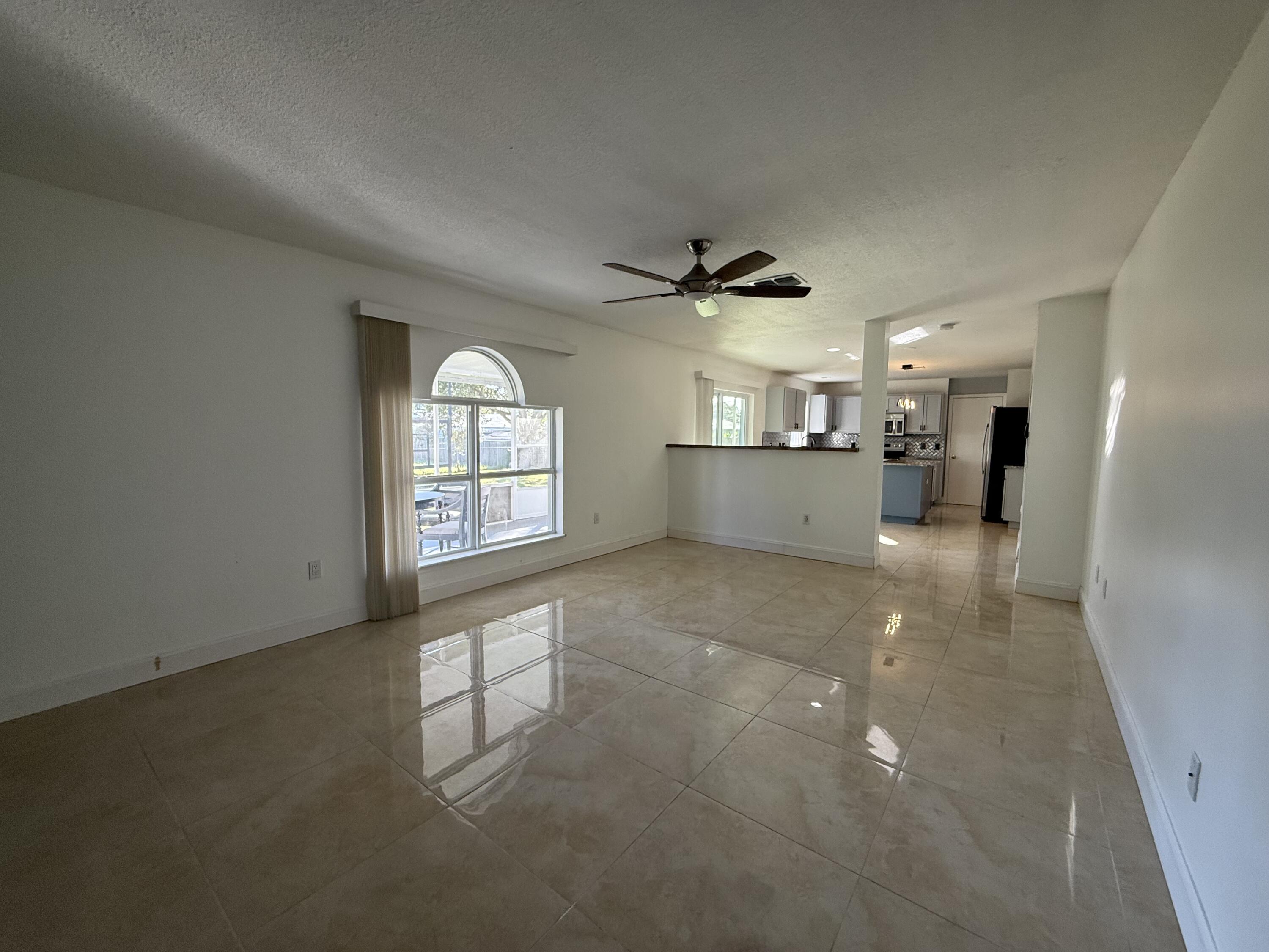1925 Southwest Libra Lane Port St. Lucie, FL 34984 - Photo 20 of 49 a view of a kitchen with a sink and a window
