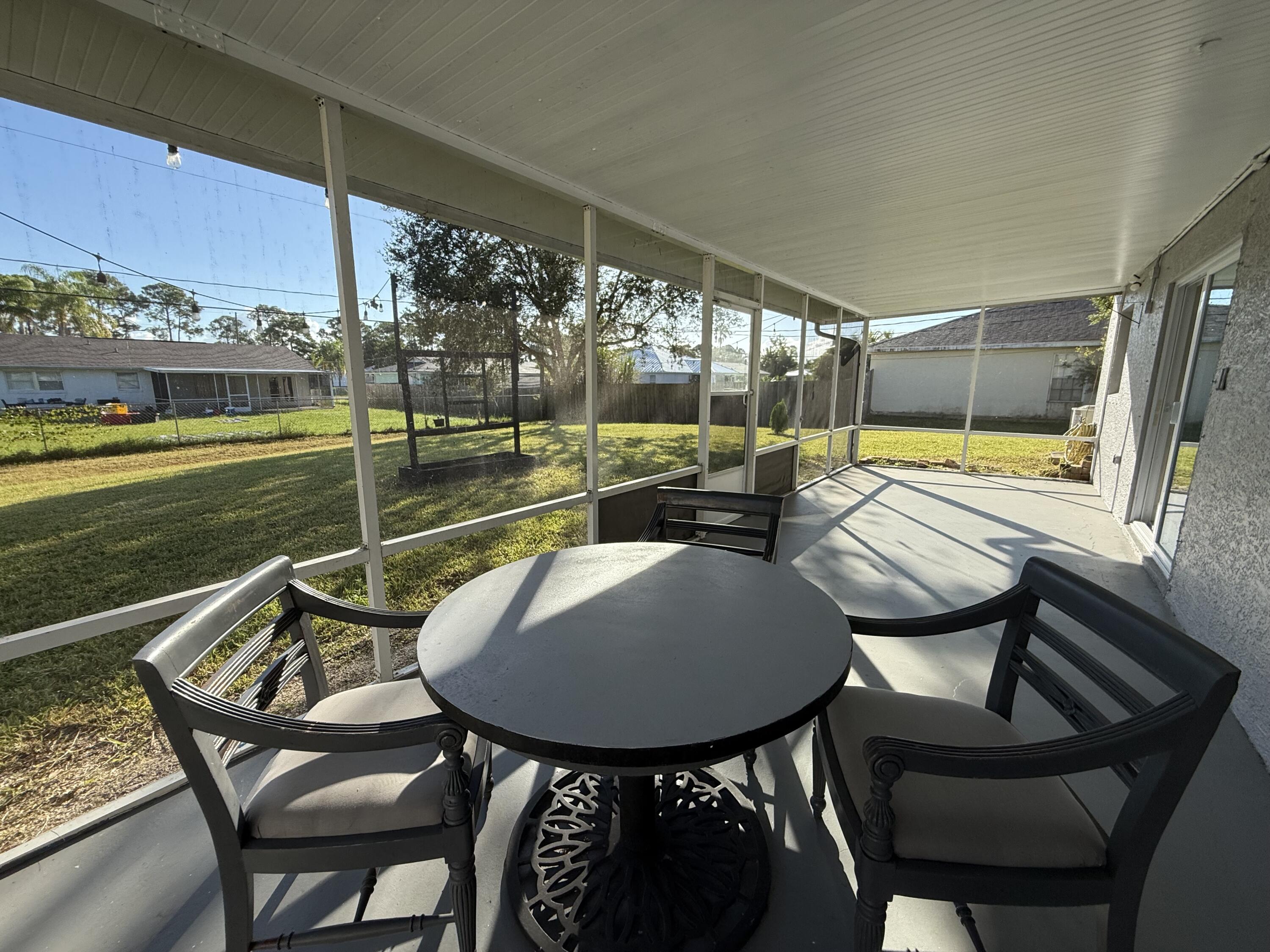 1925 Southwest Libra Lane Port St. Lucie, FL 34984 - Photo 23 of 49 a view of a chairs and table in the patio