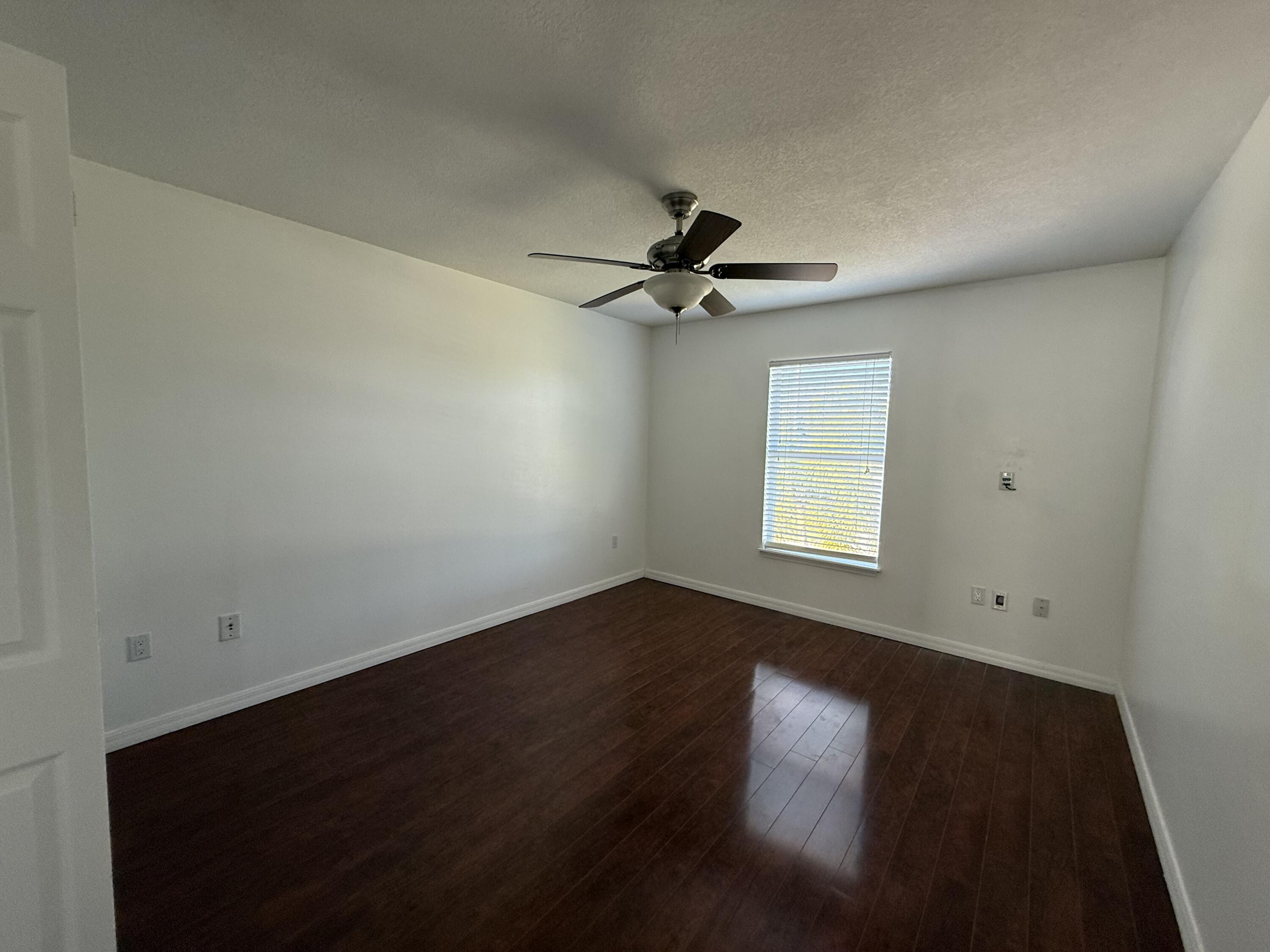 1925 Southwest Libra Lane Port St. Lucie, FL 34984 - Photo 29 of 49 an empty room with a window and a ceiling fan