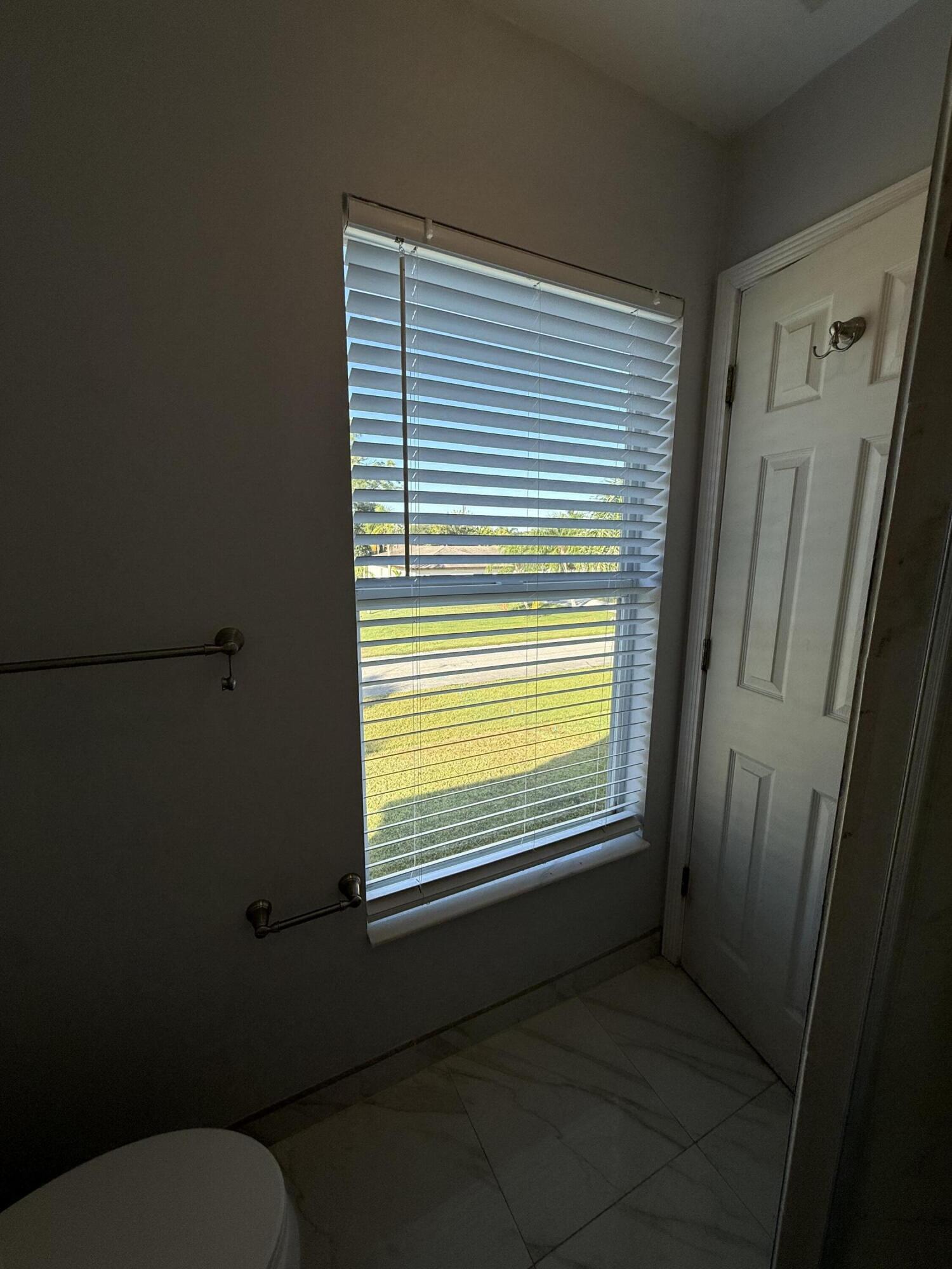 1925 Southwest Libra Lane Port St. Lucie, FL 34984 - Photo 41 of 49 a view of a bathroom with a window
