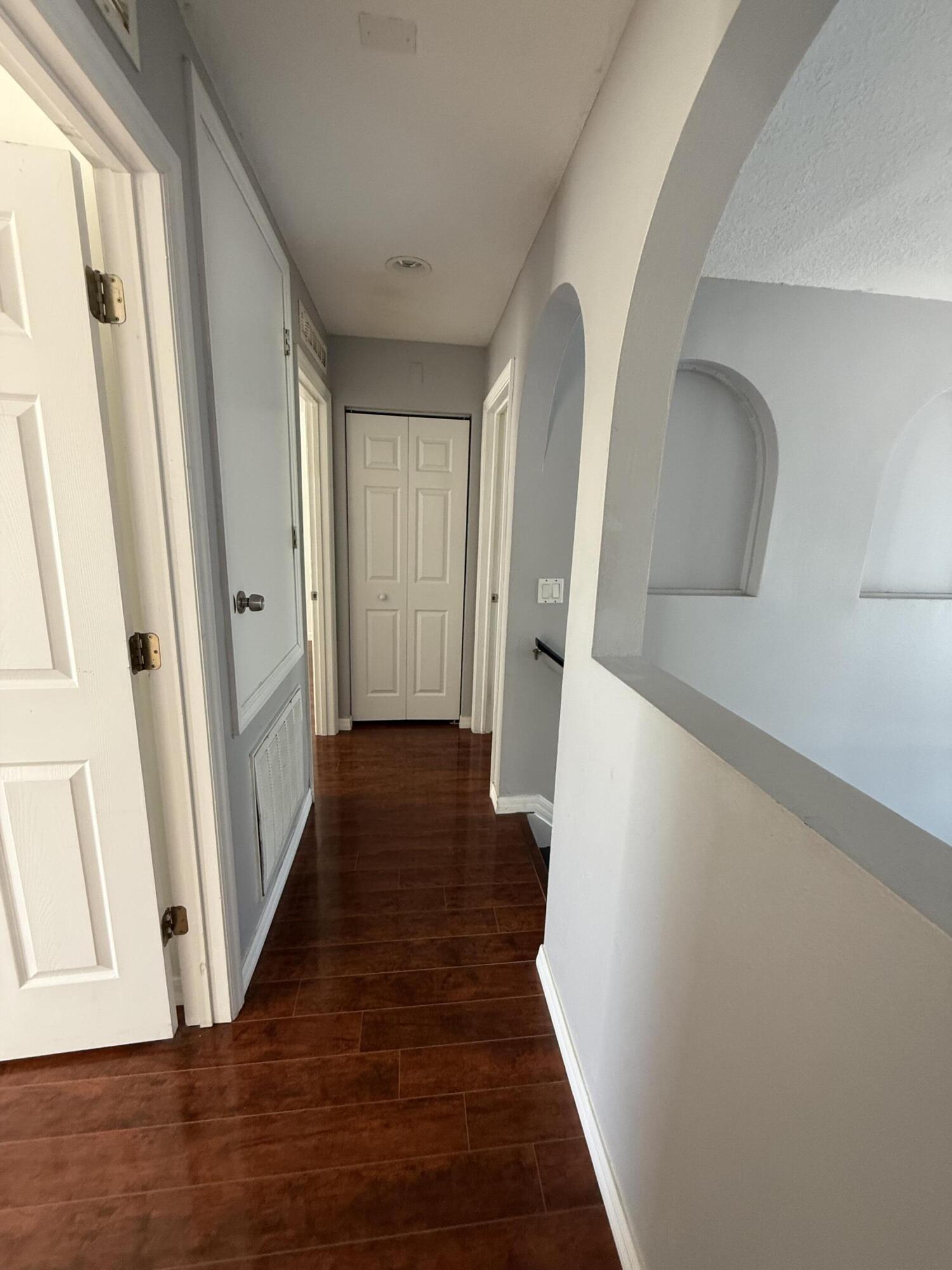 1925 Southwest Libra Lane Port St. Lucie, FL 34984 - Photo 48 of 49 a view of a hallway with wooden floor and staircase