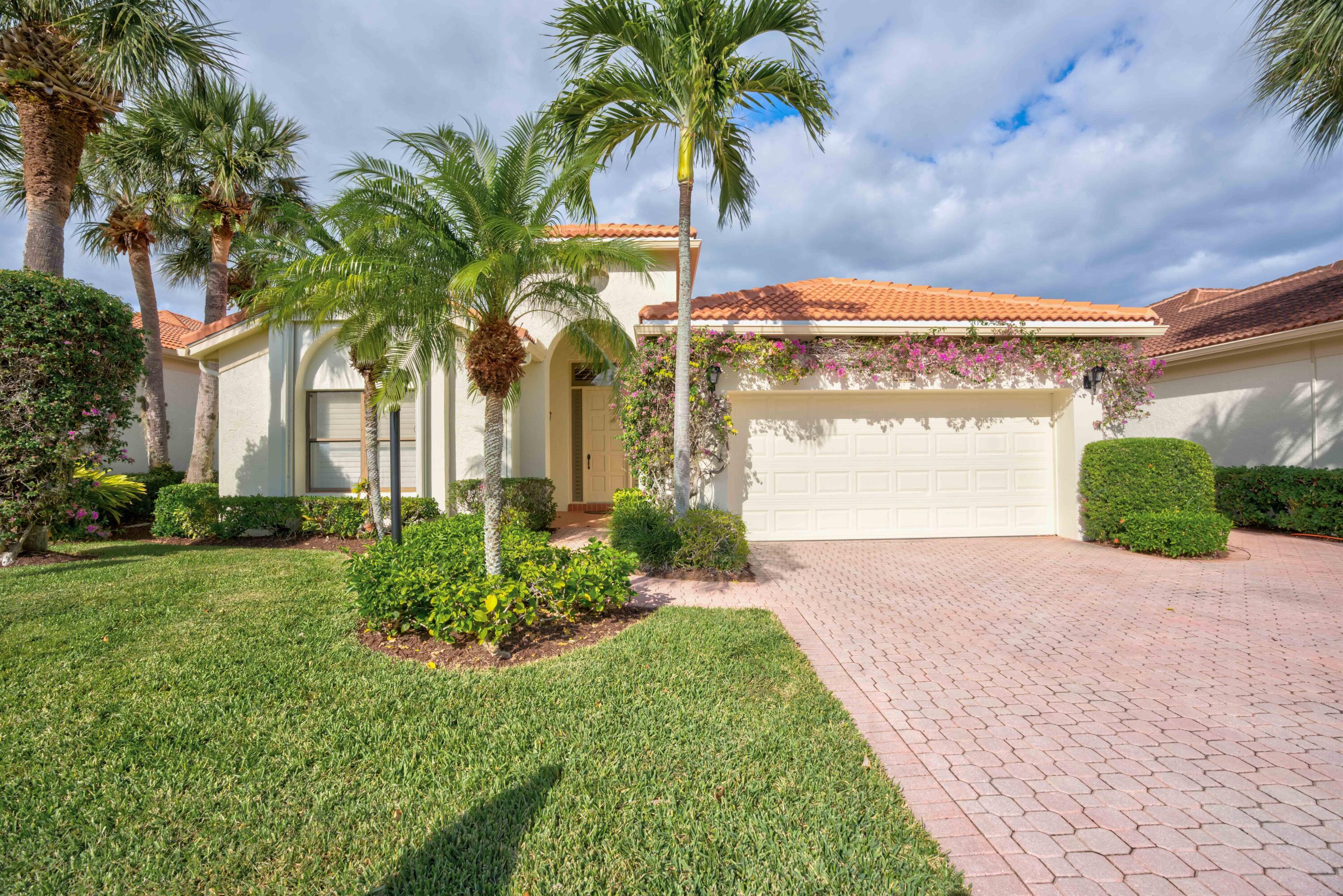 3518 Lantern Bay Drive Jupiter, FL 33477 - Photo 1 of 32 a front view of a house with garden
