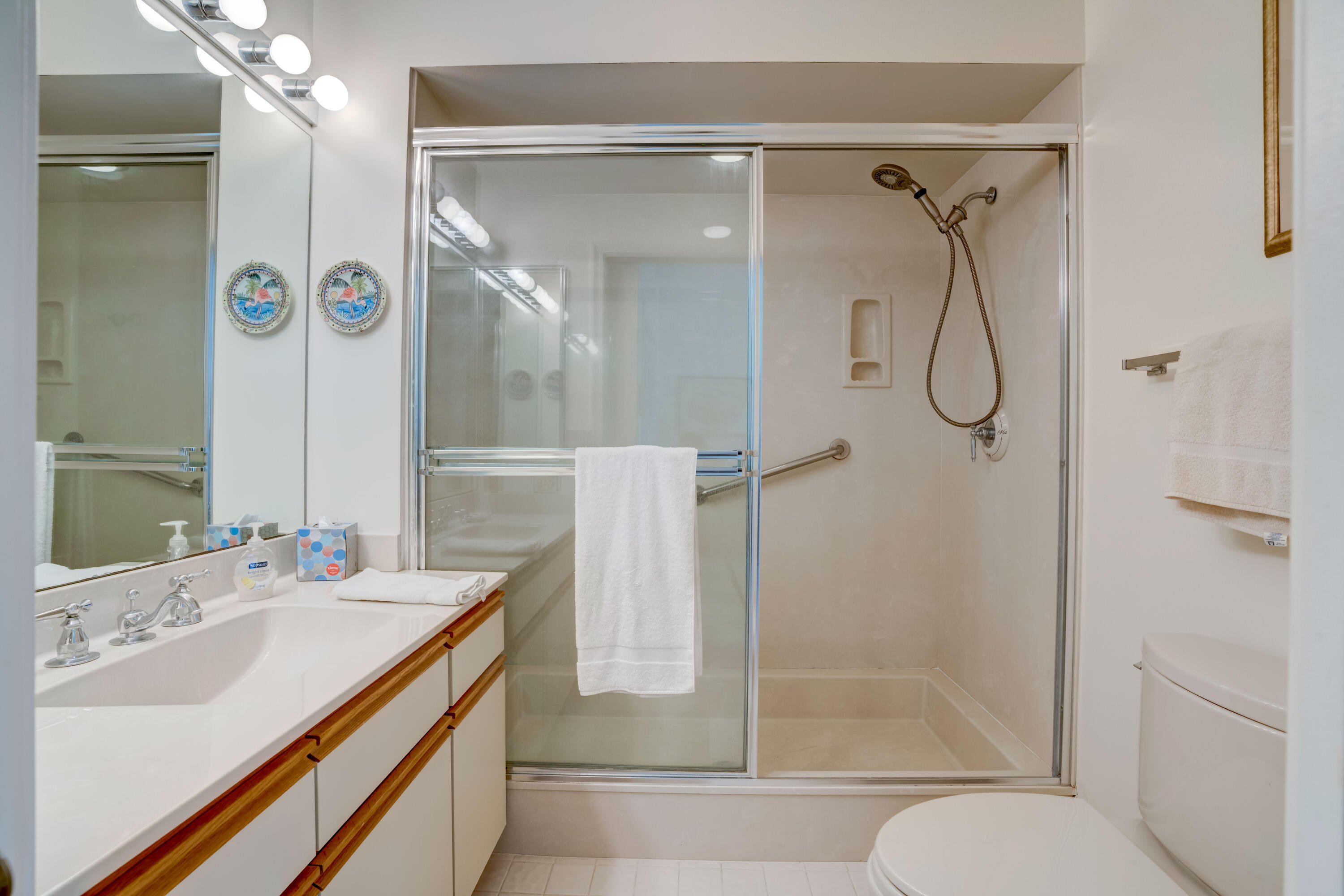 3518 Lantern Bay Drive Jupiter, FL 33477 - Photo 12 of 32 a bathroom with a shower sink vanity and mirror