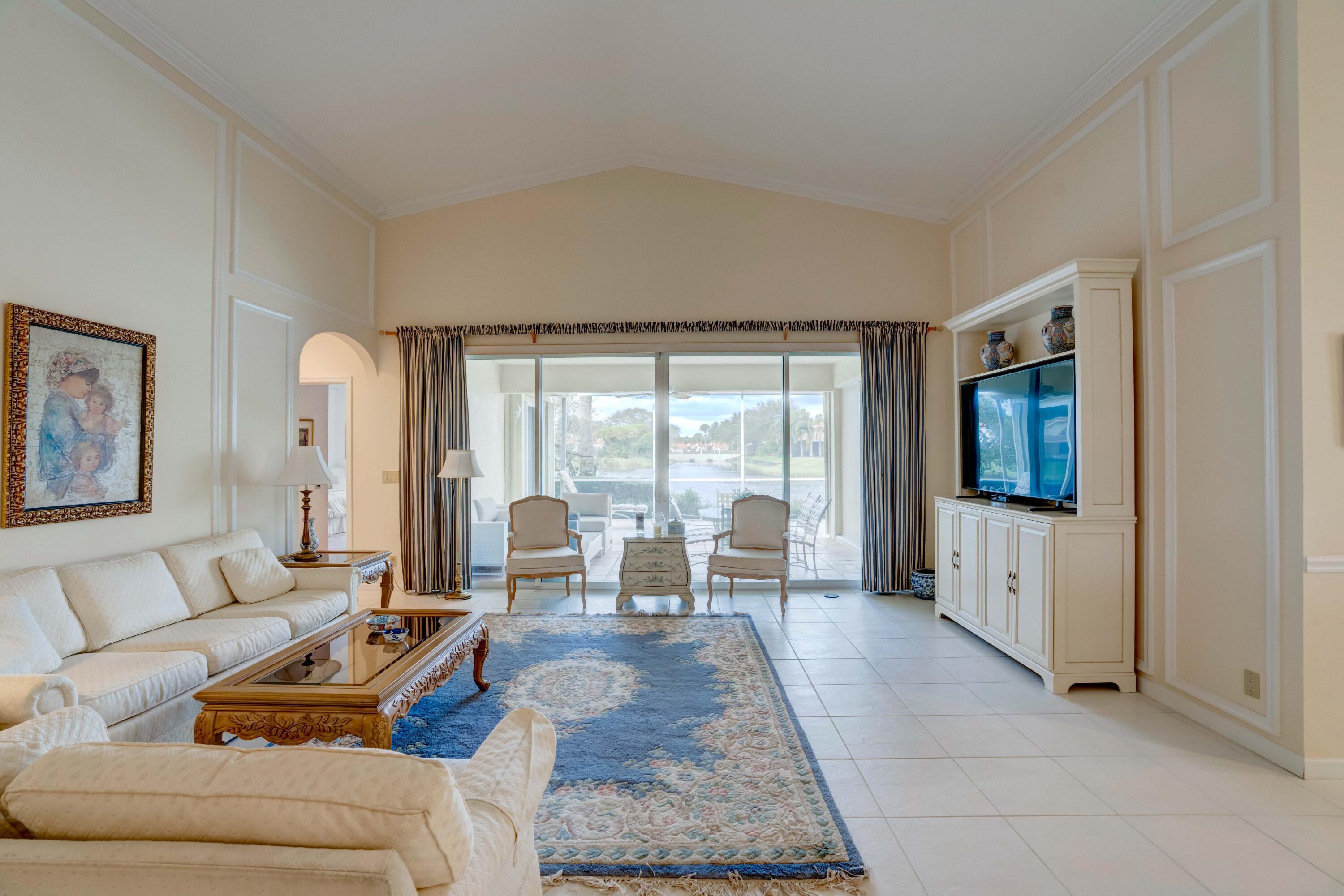 3518 Lantern Bay Drive Jupiter, FL 33477 - Photo 13 of 32 a living room with furniture and a flat screen tv