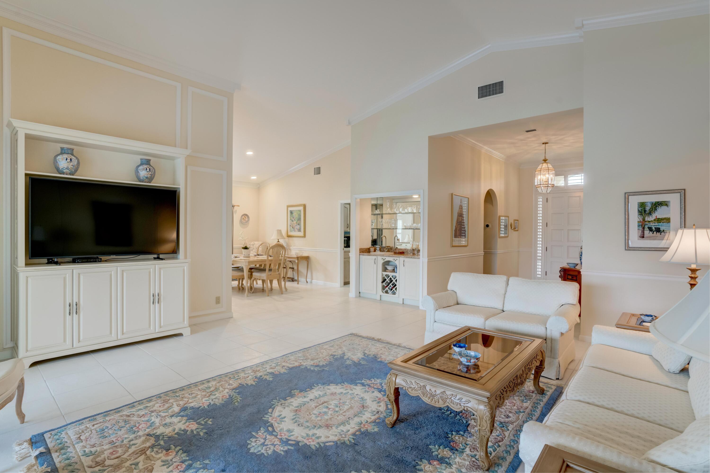 3518 Lantern Bay Drive Jupiter, FL 33477 - Photo 15 of 32 a living room with furniture and a flat screen tv