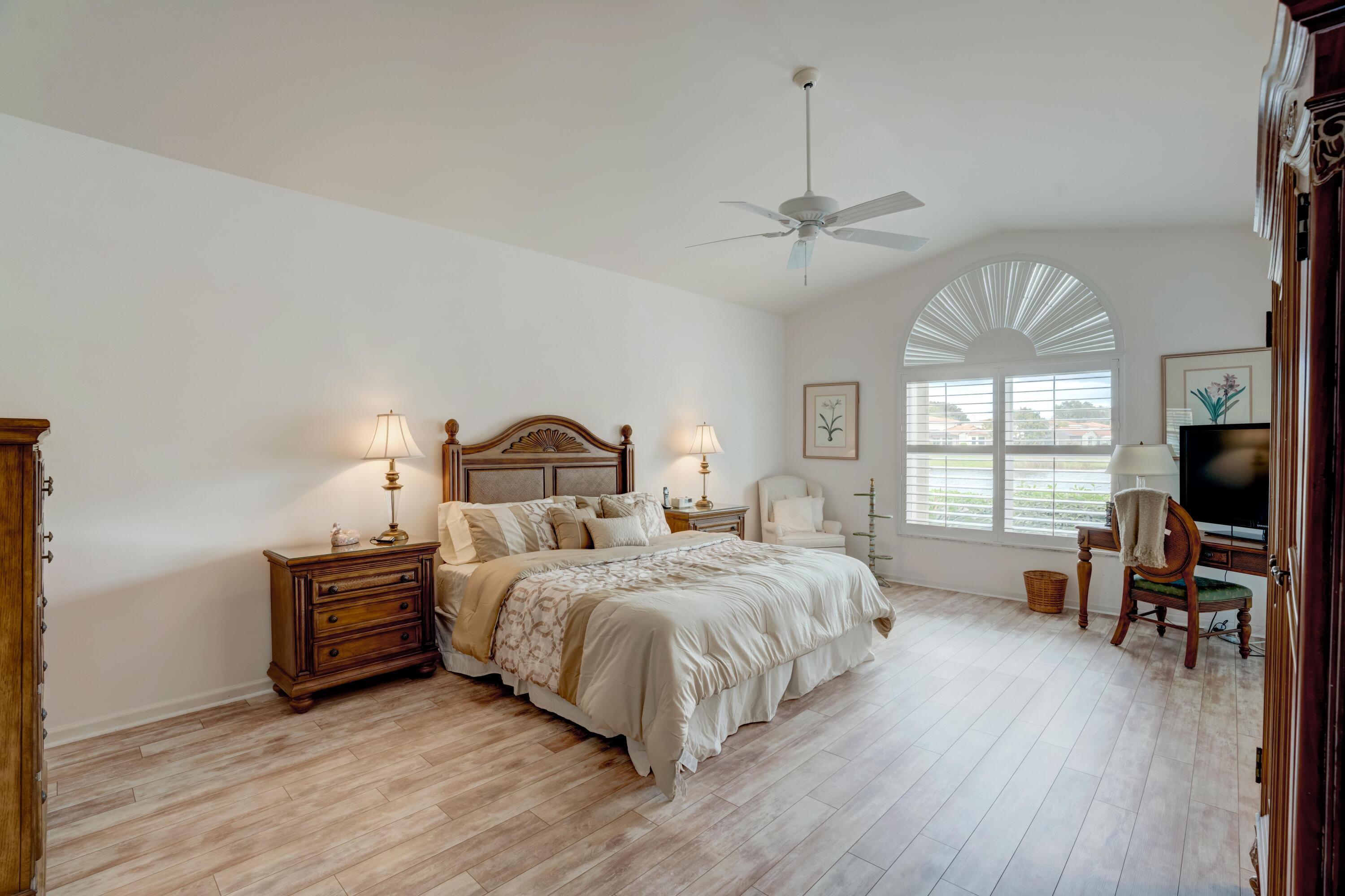 3518 Lantern Bay Drive Jupiter, FL 33477 - Photo 16 of 32 a bedroom with bed window and flat screen tv