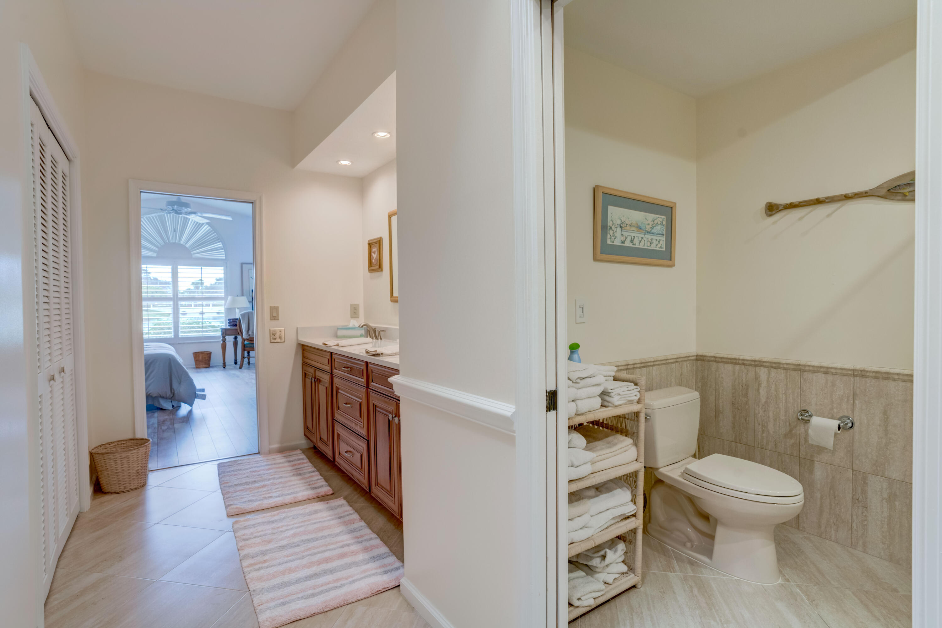 3518 Lantern Bay Drive Jupiter, FL 33477 - Photo 22 of 32 a white toilet sitting next to a bathroom sink