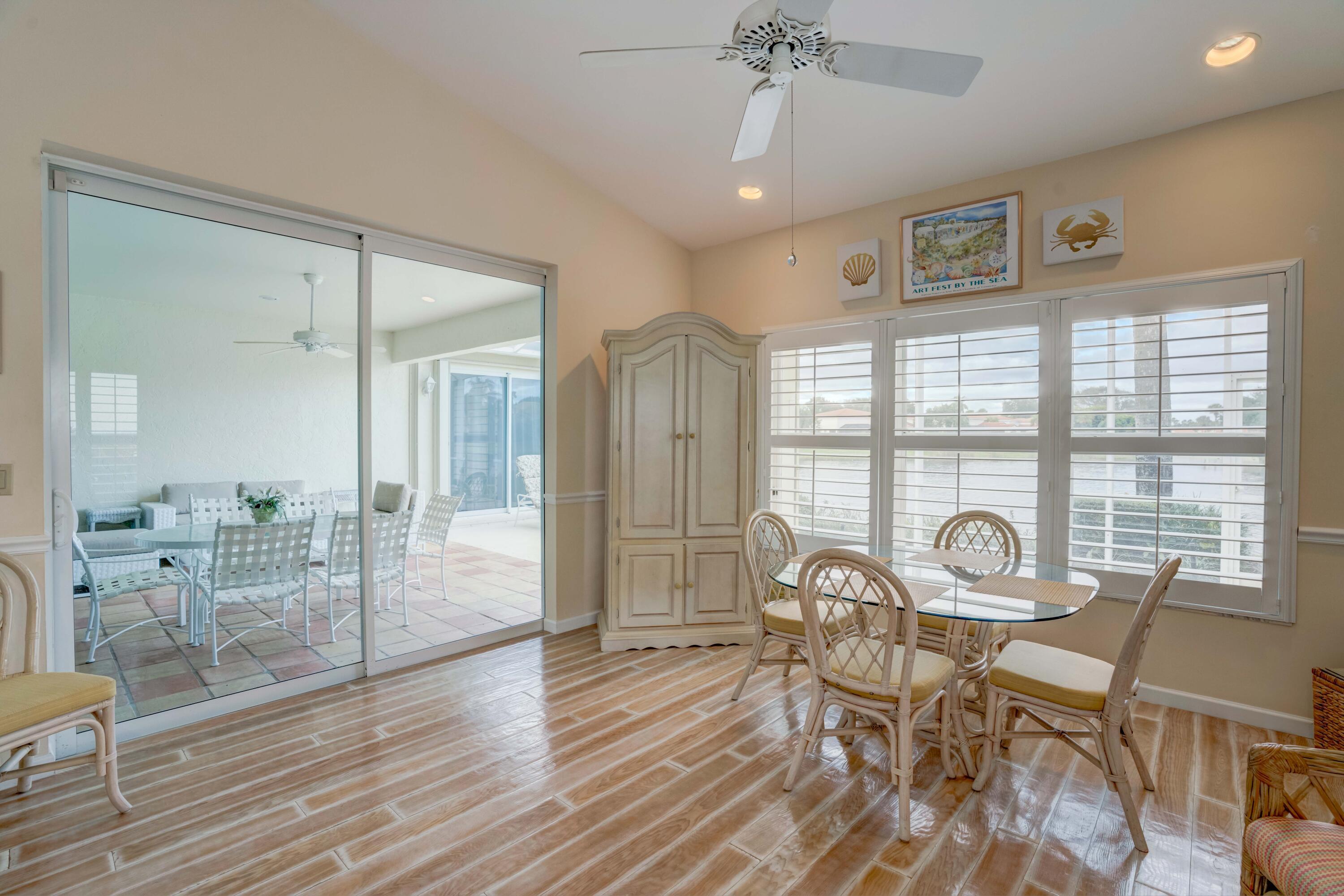 3518 Lantern Bay Drive Jupiter, FL 33477 - Photo 30 of 32 a view of a dining room with furniture window and wooden floor