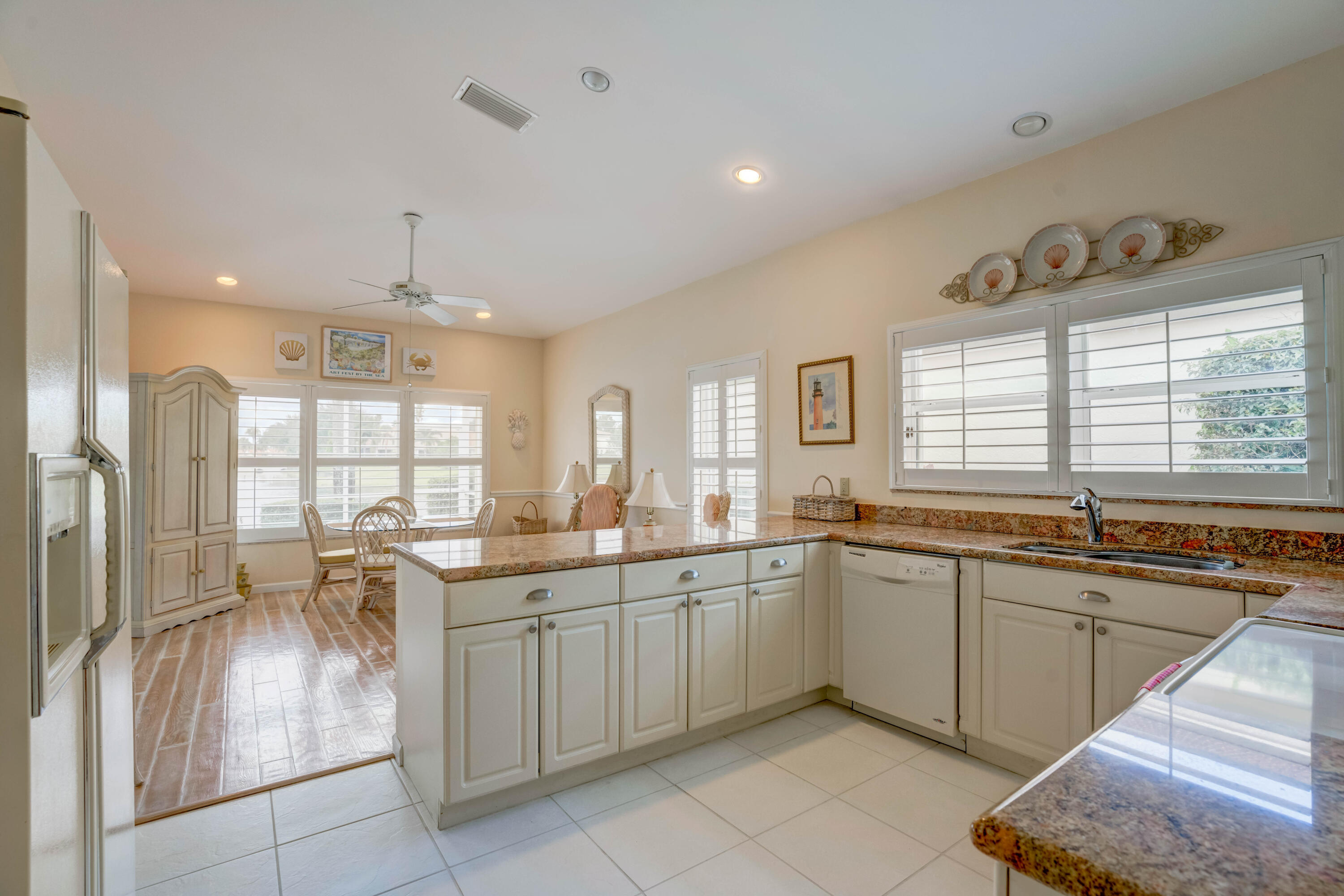 3518 Lantern Bay Drive Jupiter, FL 33477 - Photo 3 of 32 a large kitchen with kitchen island a sink stainless steel appliances and cabinets