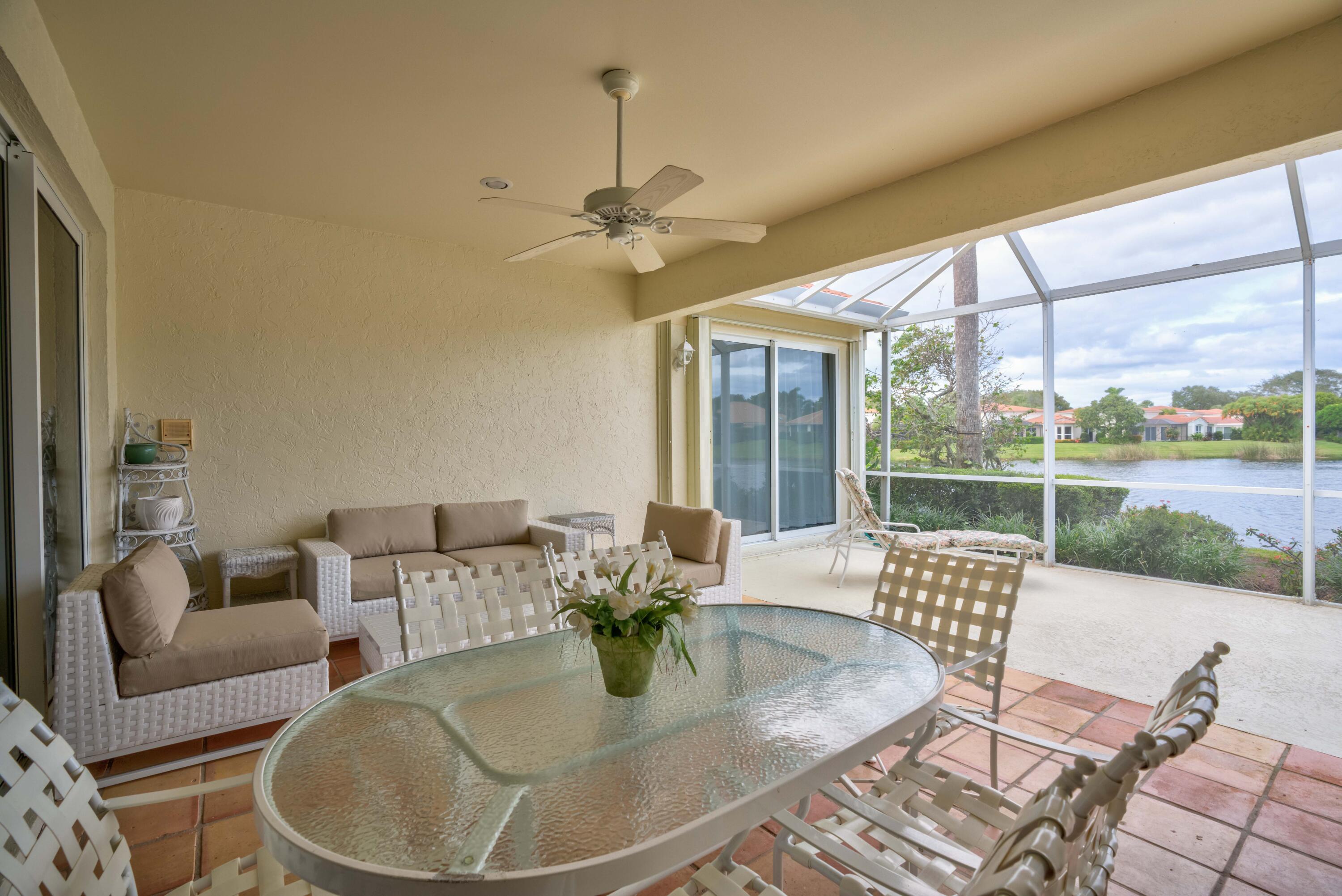 3518 Lantern Bay Drive Jupiter, FL 33477 - Photo 32 of 32 a dining room with furniture a chandelier and wooden floor