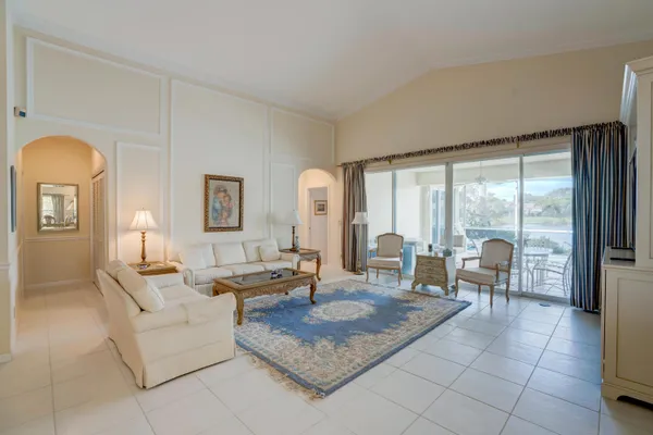 a living room with furniture and large windows
