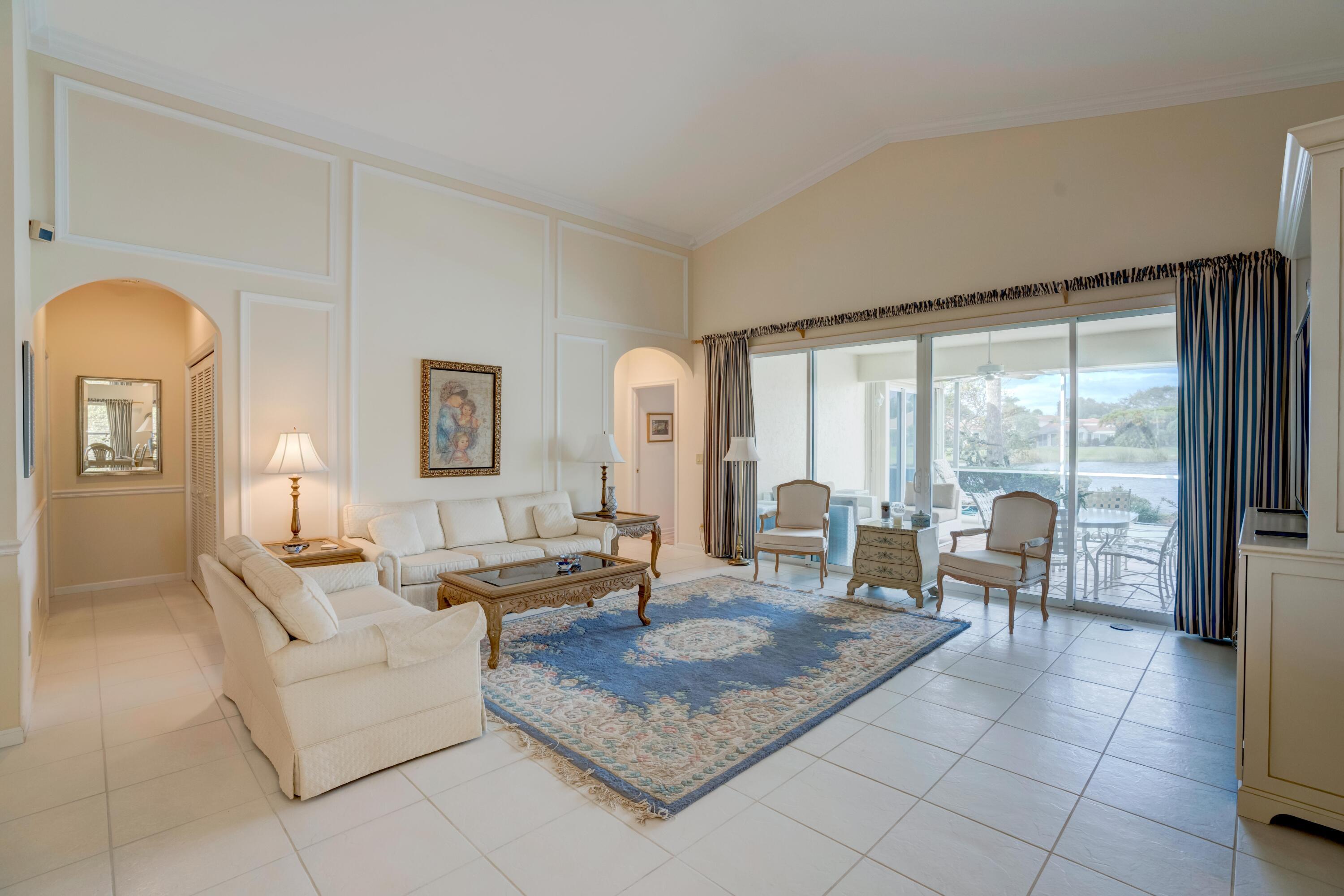 3518 Lantern Bay Drive Jupiter, FL 33477 - Photo 4 of 32 a living room with furniture and large windows