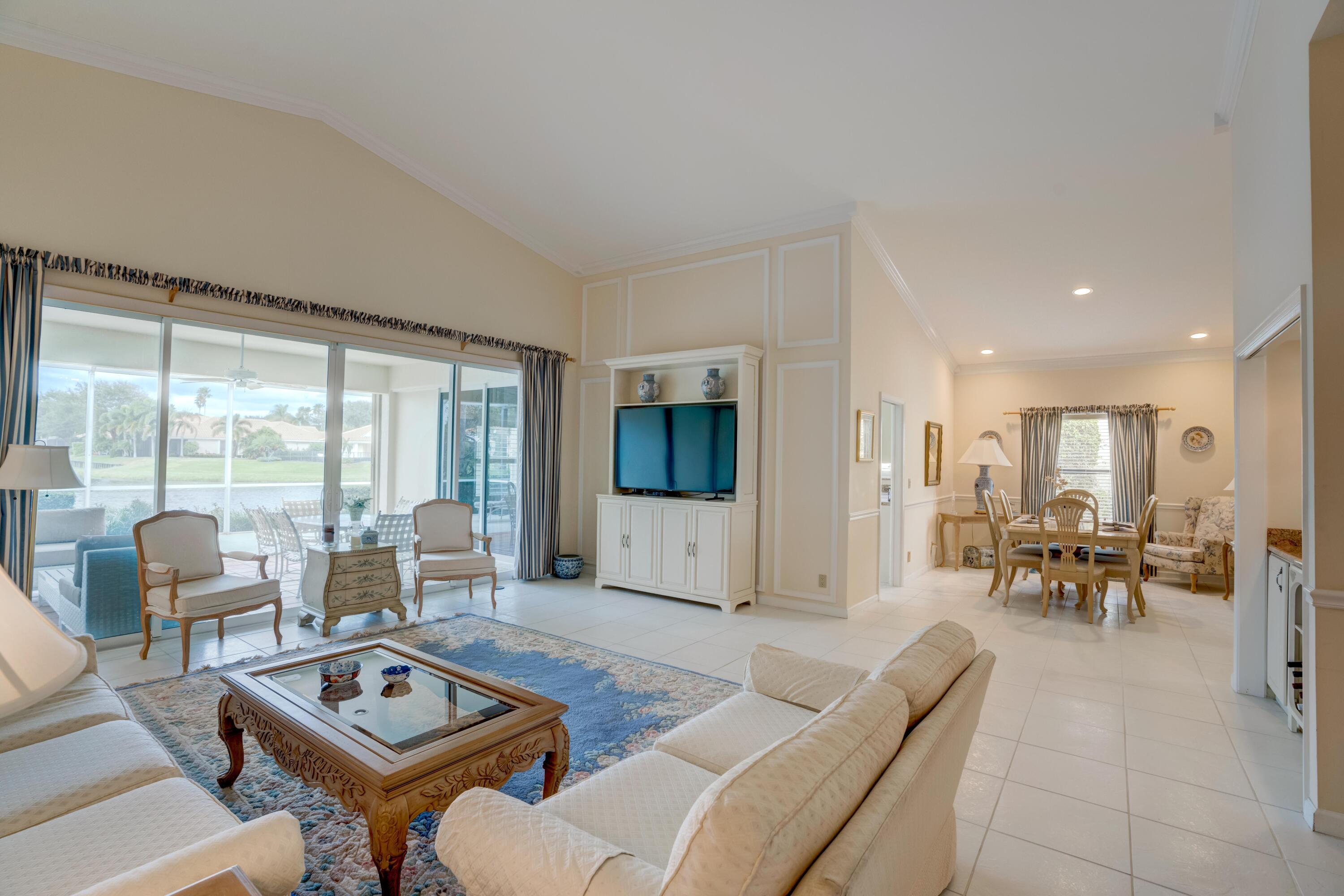 3518 Lantern Bay Drive Jupiter, FL 33477 - Photo 5 of 32 a living room with furniture and a table