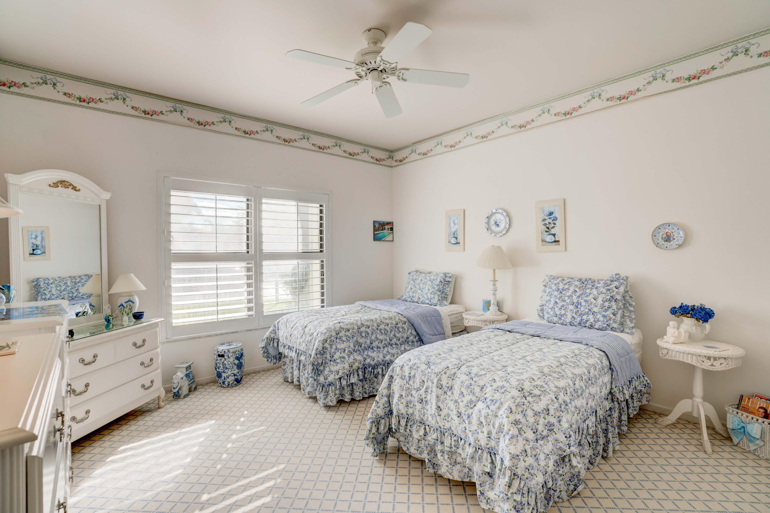 3518 Lantern Bay Drive Jupiter, FL 33477 - Photo 7 of 32 a spacious bedroom with two bed and a window