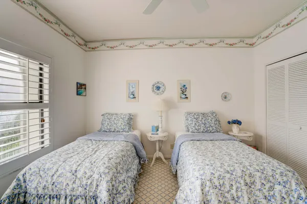 a bedroom with two bed and a window