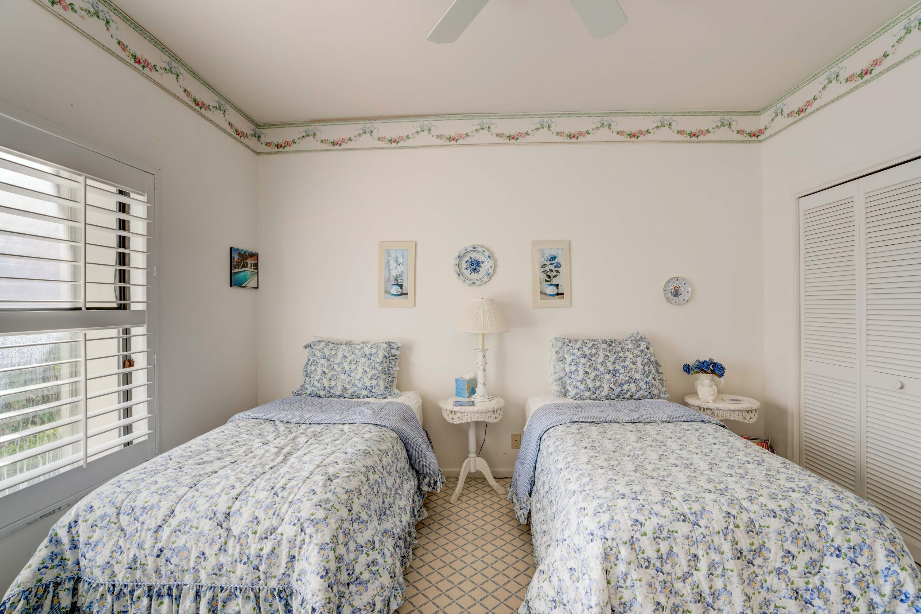 3518 Lantern Bay Drive Jupiter, FL 33477 - Photo 8 of 32 a bedroom with two bed and a window